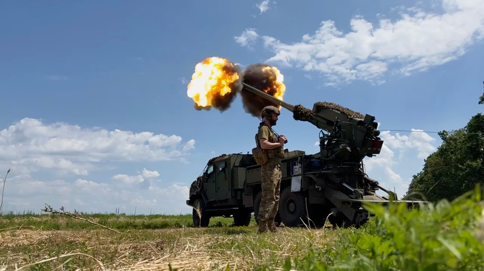 A Ukrainian soldier stands beside a howitzer on July 7 near Bakhmut in eastern Ukraine.
