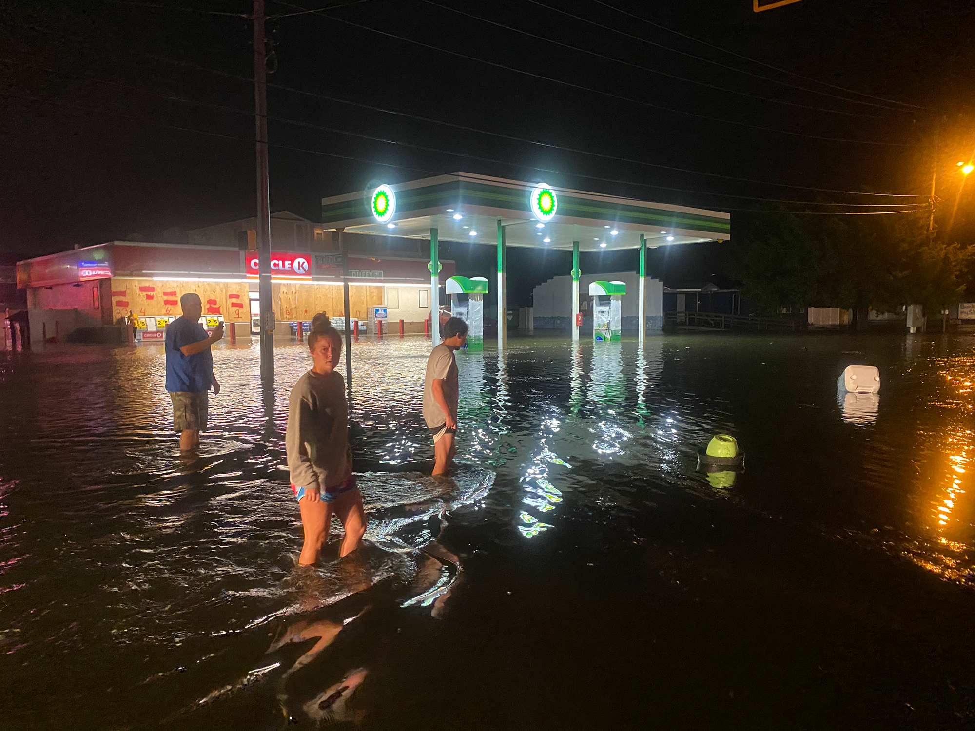 People walk on the flooded Sea Mountain highway in North Myrtle Beach, South Carolina, late Monday night.