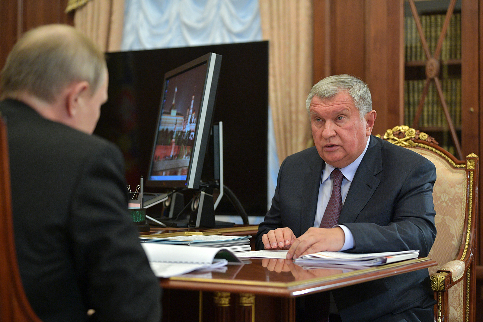 Russia's President Vladimir Putin (L) and Rosneft CEO Igor Sechin talk during a meeting at the Kremlin in Moscow, Russia, on February 11, 2020.