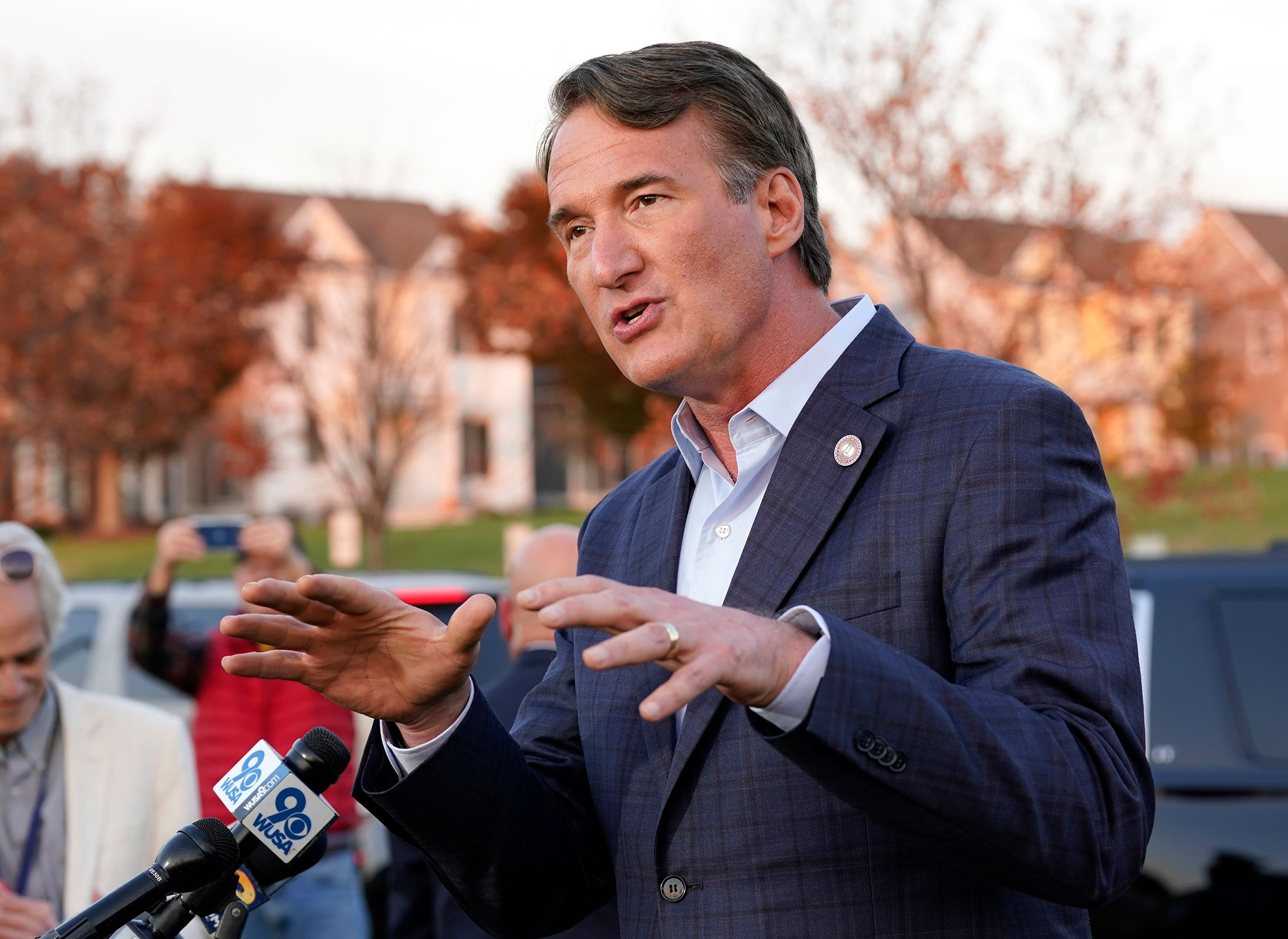 Virginia Gov. Glenn Youngkin gestures as he talks with reporters after greeting voters at a polling station on Tuesday.