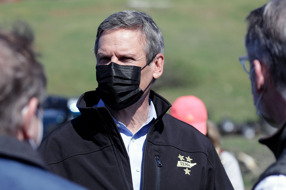 Tennessee Gov. Bill Lee, center, visits a storm-damaged area Tuesday, April 14, in Chattanooga, Tennessee. 