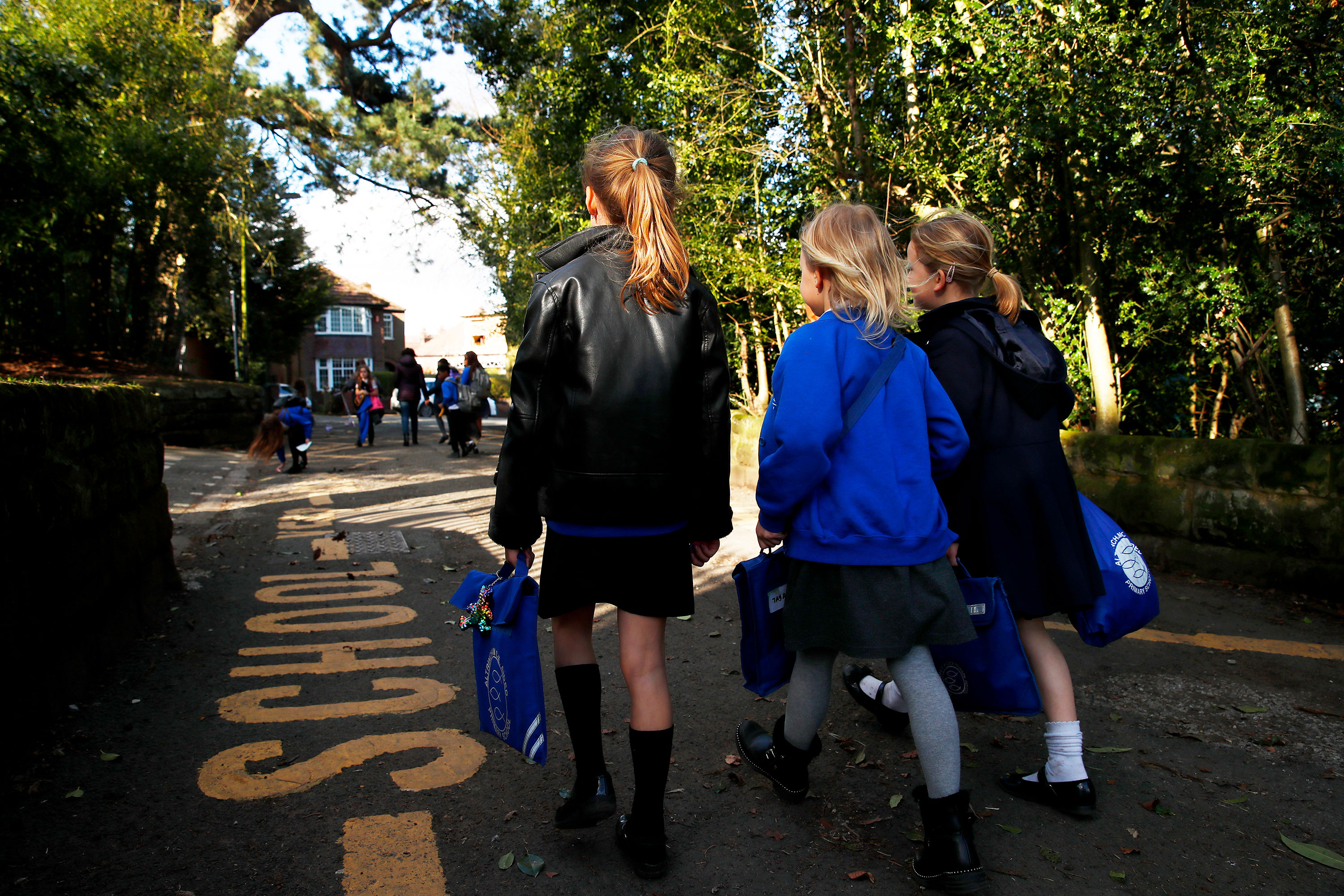 Children walk home from school in Altrincham, England, on March 20.