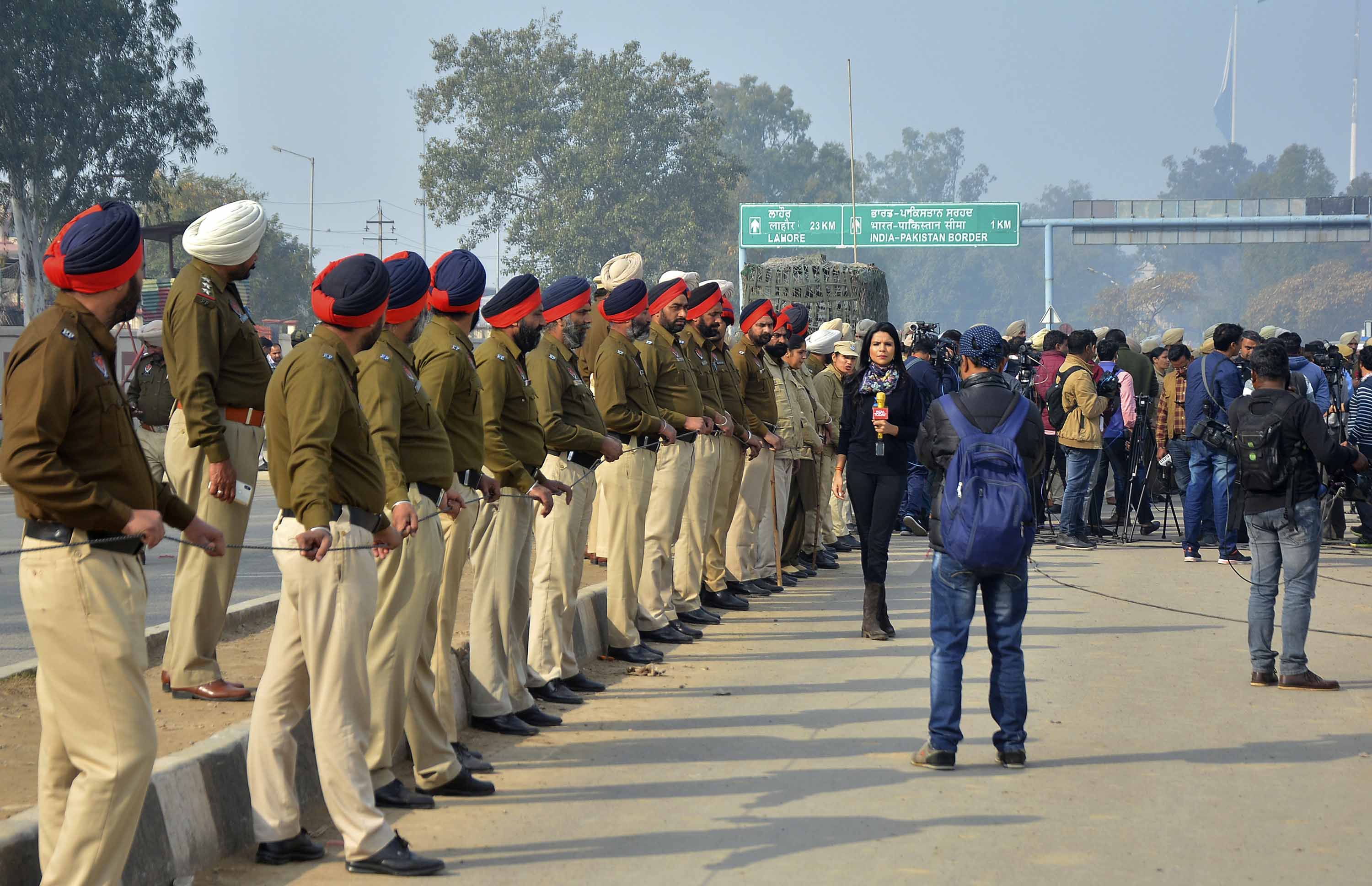 Officers await the return of the Indian pilot on the Indian side of the Wagah border crossing on Friday, March 1.