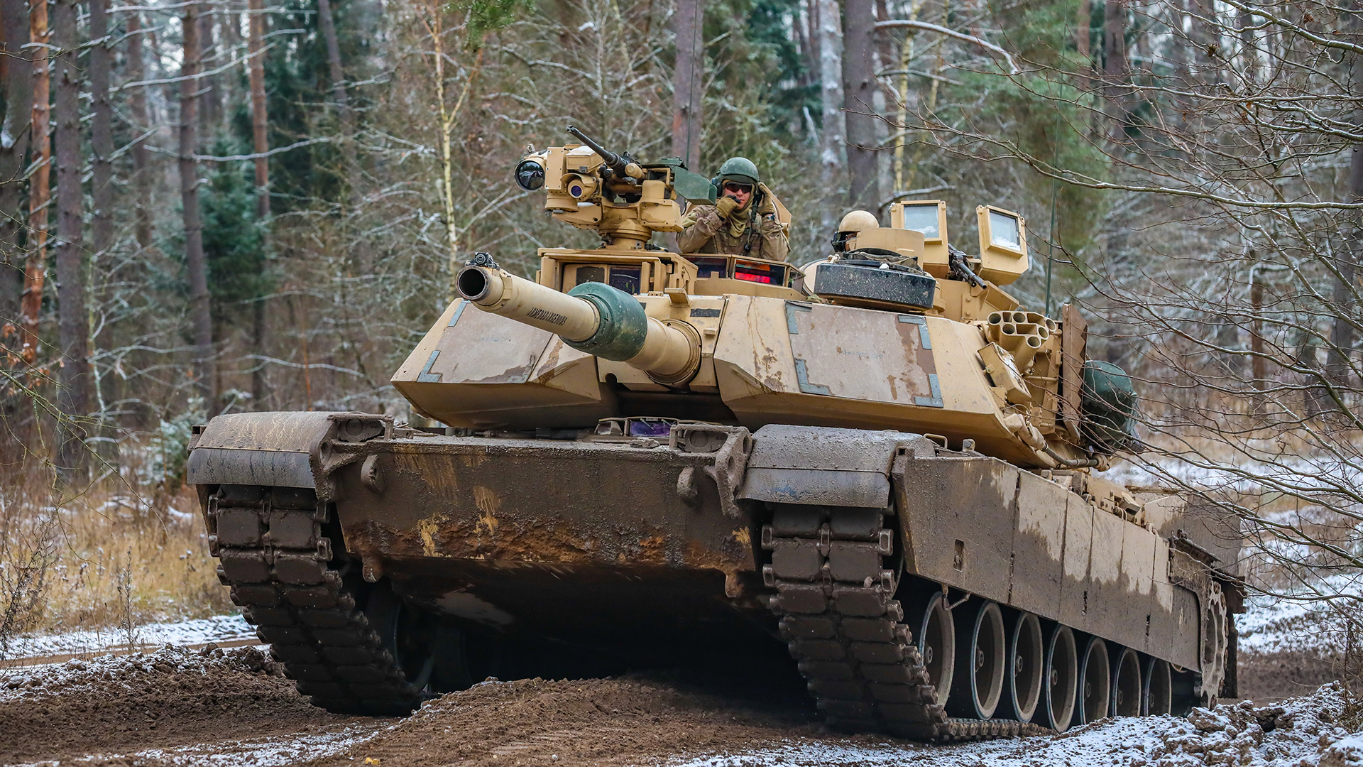 US soldiers operate an Abrams M1-A1 tank to engage a simulated opposing force during the Bull Run training exercise at Bemowo Piskie, Poland, in November 2022.