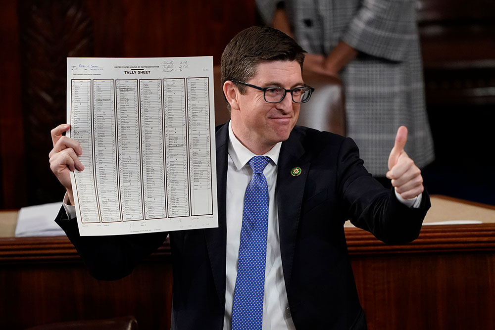 US Rep. Bryan Steil, a Republican from Wisconsin, holds up the tally sheet after the deciding vote.