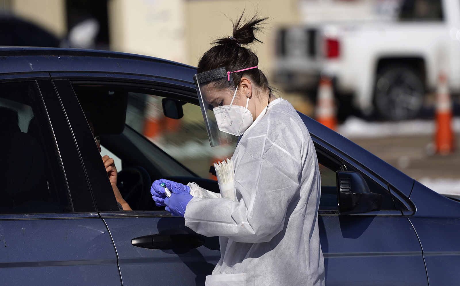 In this Oct. 27, 2020, file photo, a tester prepares to administer a swab test at a drive-in Covid-19 testing site in Federal Heights, Colorado.