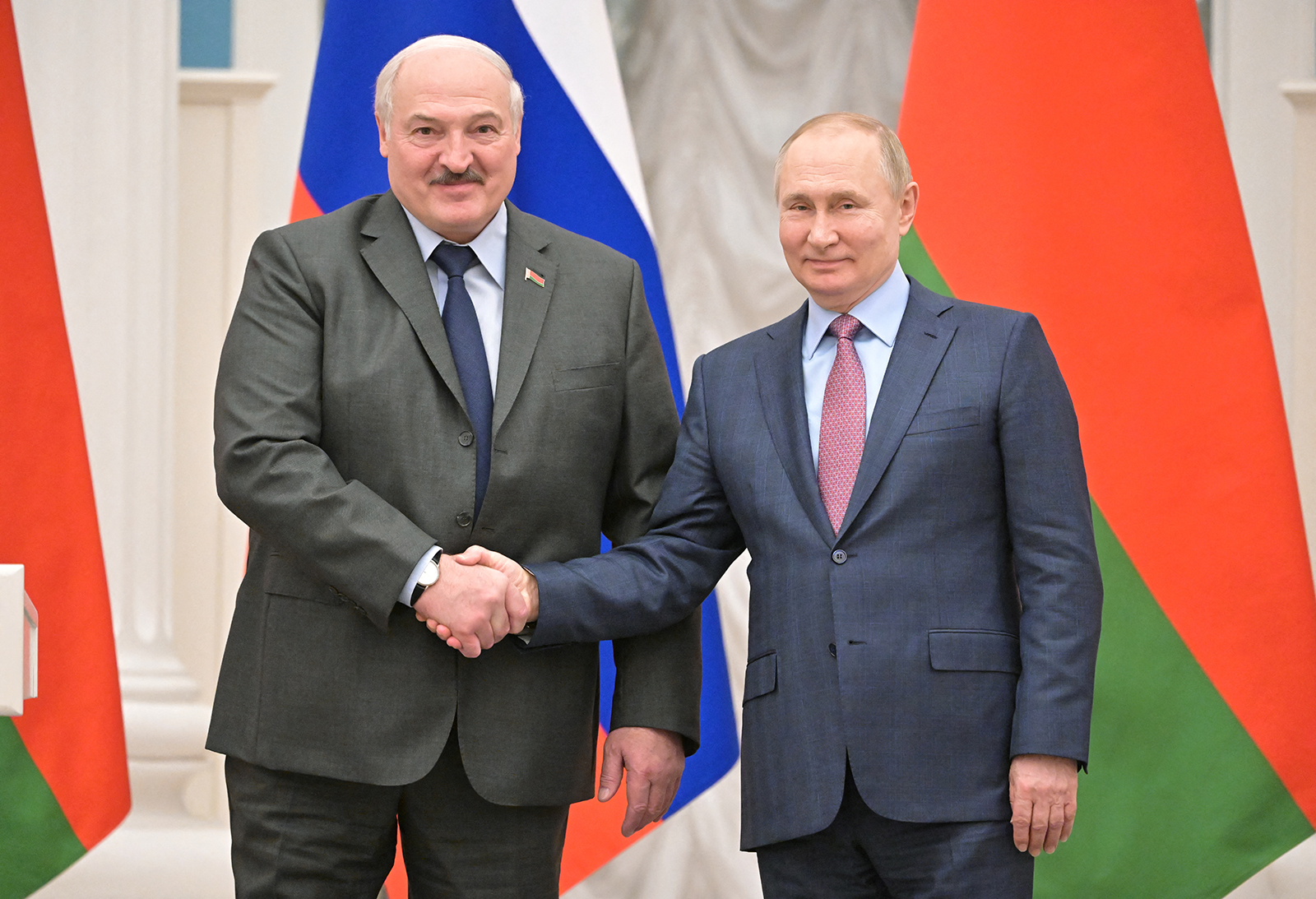 Russian President Vladimir Putin and Belarusian President Alexander Lukashenko shake hands during a joint news conference in Moscow, Russia, on February 18.