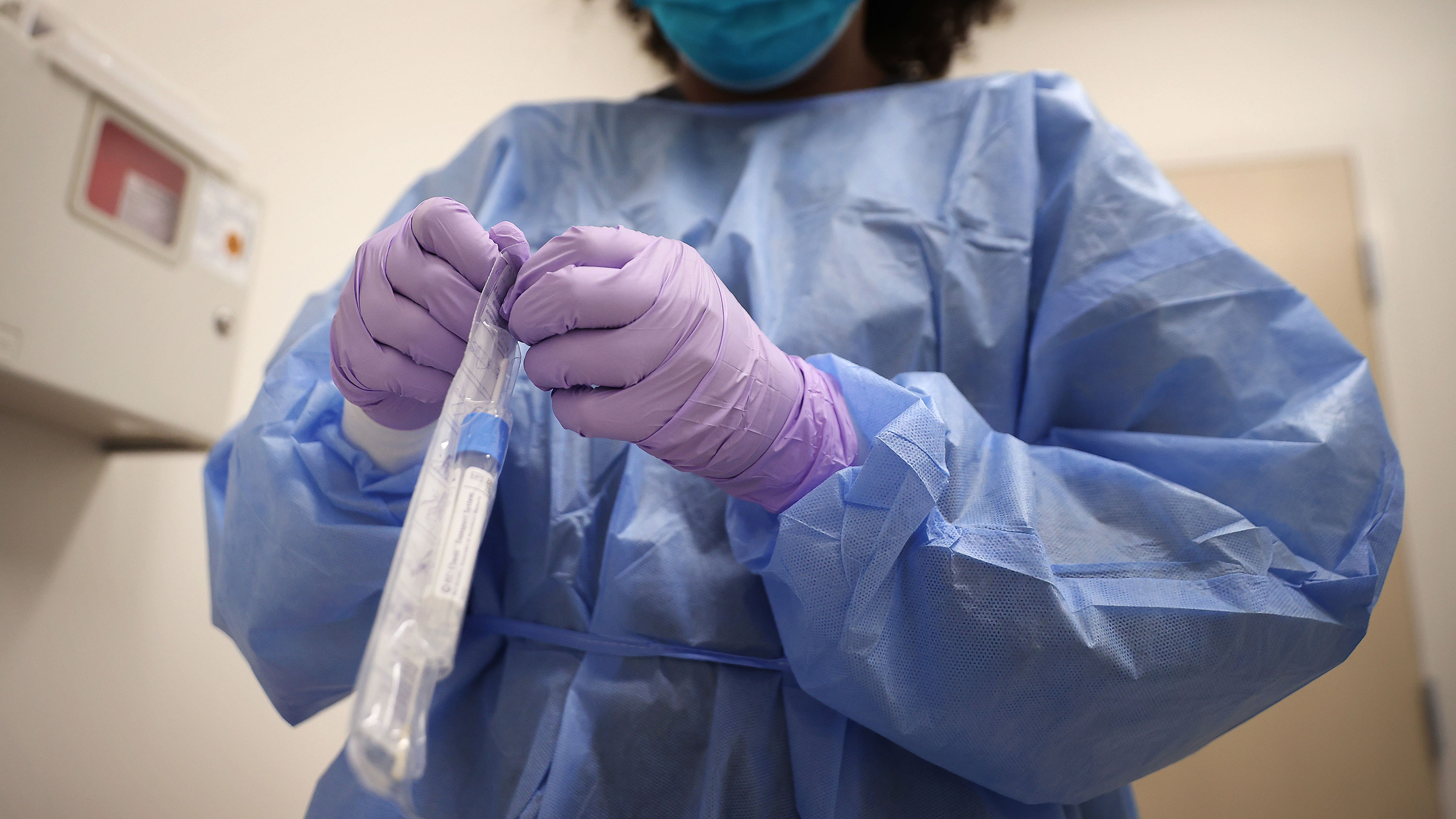 A medical worker prepares to test a patient for coronavirus on April 15, in Woodbridge, Virginia. 