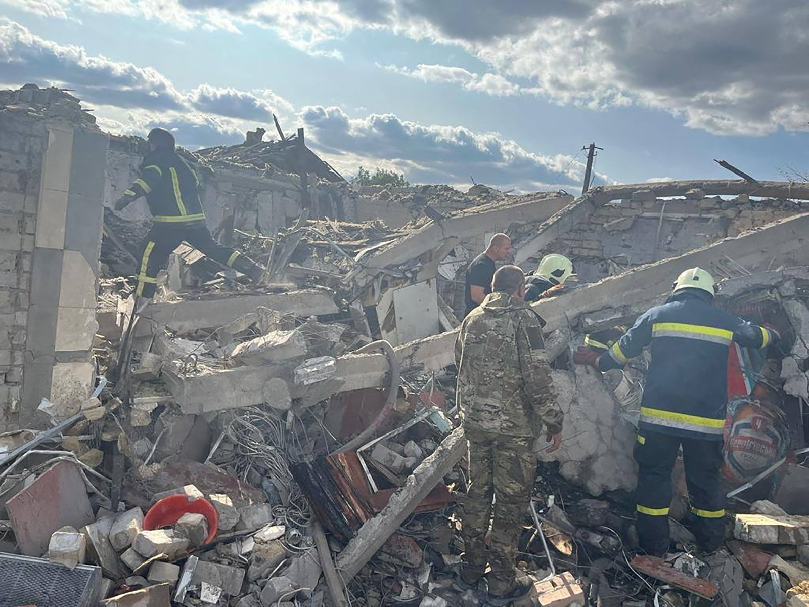 Rescuers work at a site of a Russian military strike in the village of Hroza, in Kharkiv region, Ukraine, on October 5.