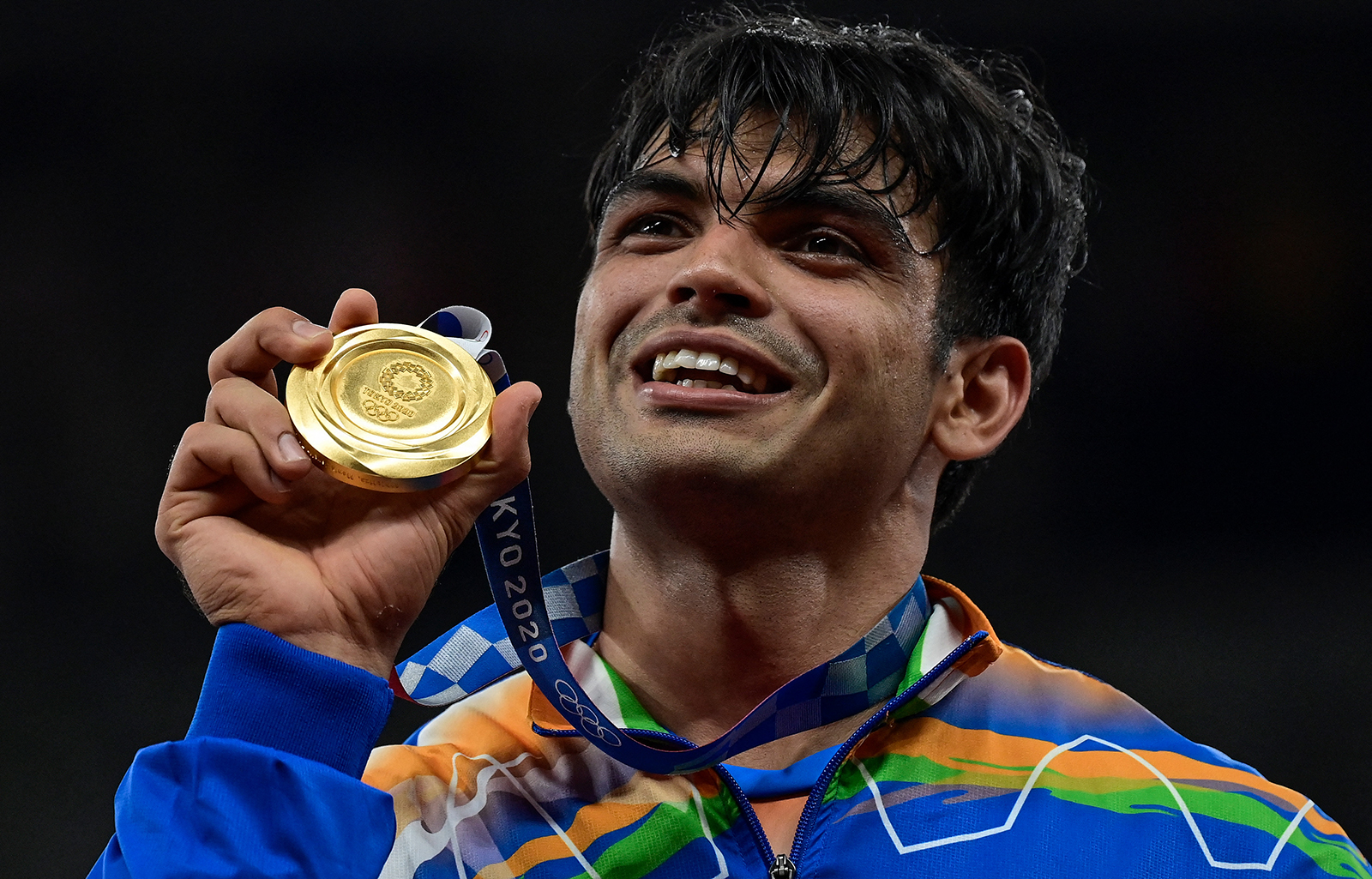 India's Neeraj Chopra celebrates on the podium during the victory ceremony for winning gold in the men's javelin throw event during the Tokyo 2020 Olympic Games at the Olympic Stadium in Tokyo on August 7.