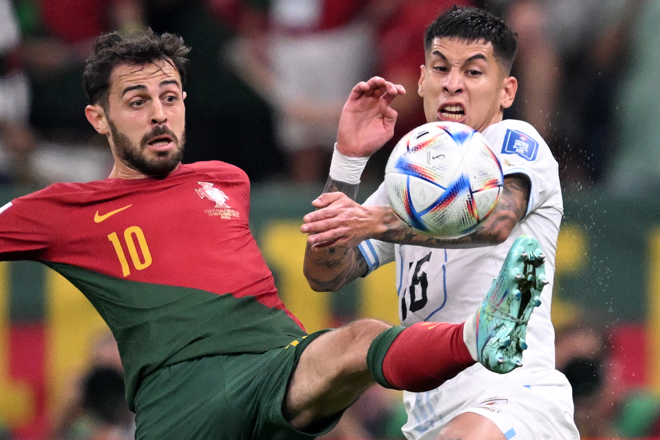 Portugal's Bernardo Silva, left, fights for the ball with Uruguay's Mathias Olivera on Monday.