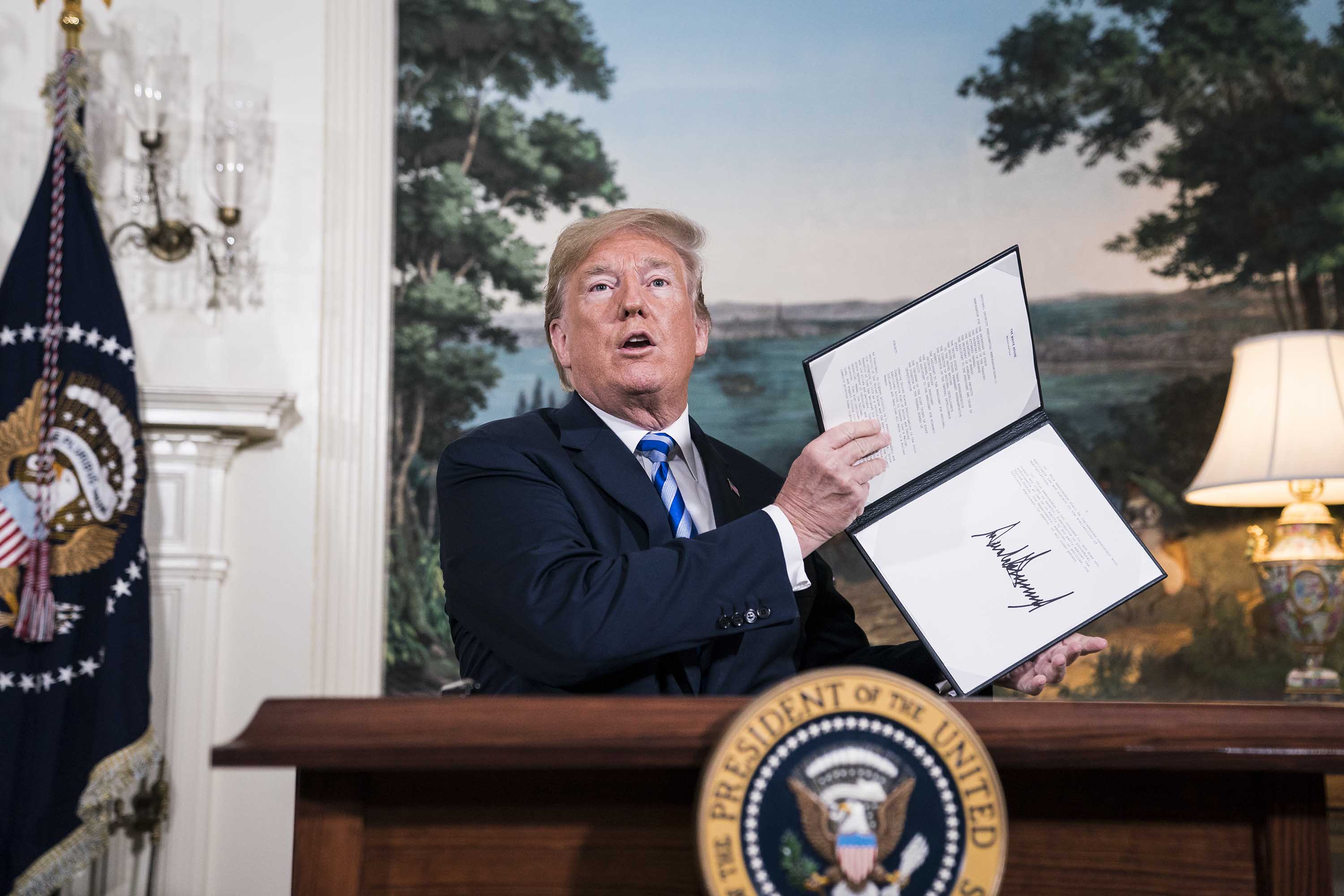 President Trump signs a National Security Presidential Memorandum as he announces the withdrawal of the US from the Iran nuclear deal during a "Joint Comprehensive Plan of Action" event at the White House in May 2018. Credit: Jabin Botsford/The Washington Post via Getty Images