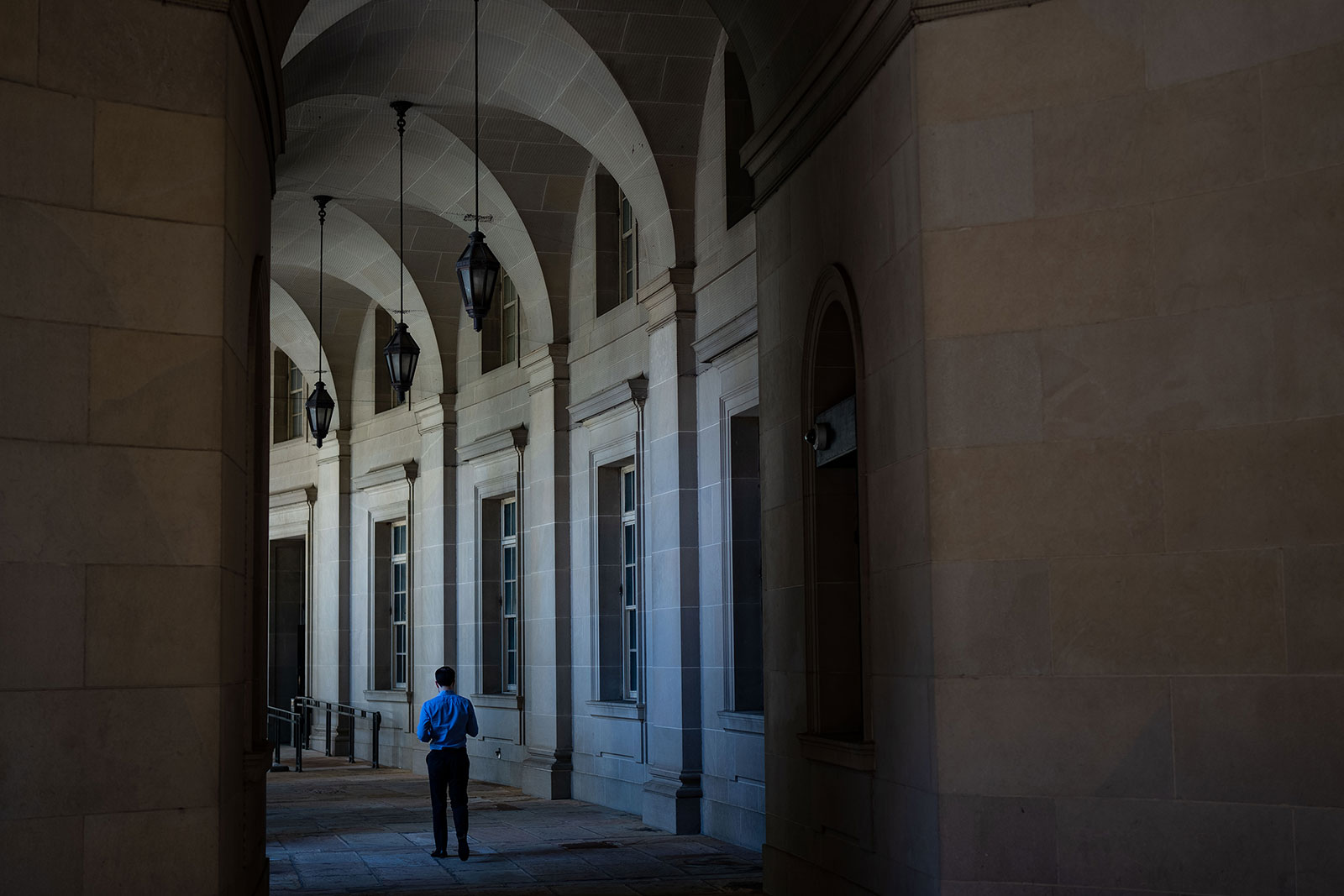 A person walks along the exterior of the Internal Revenue Service building in Washington, DC, in August 2022.
