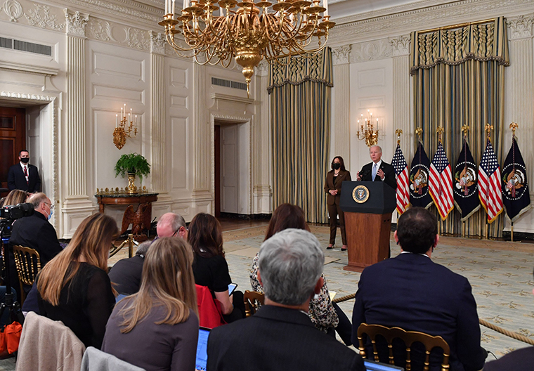 US President Joe Biden delivers remarks on the passage of the Bipartisan Infrastructure Deal and the rule that will allow the passage of the Build Back Better Act, as US Vice President Kamala Harris looks on in the State Dining Room at the White House in Washington, DC on November 6, 2021.