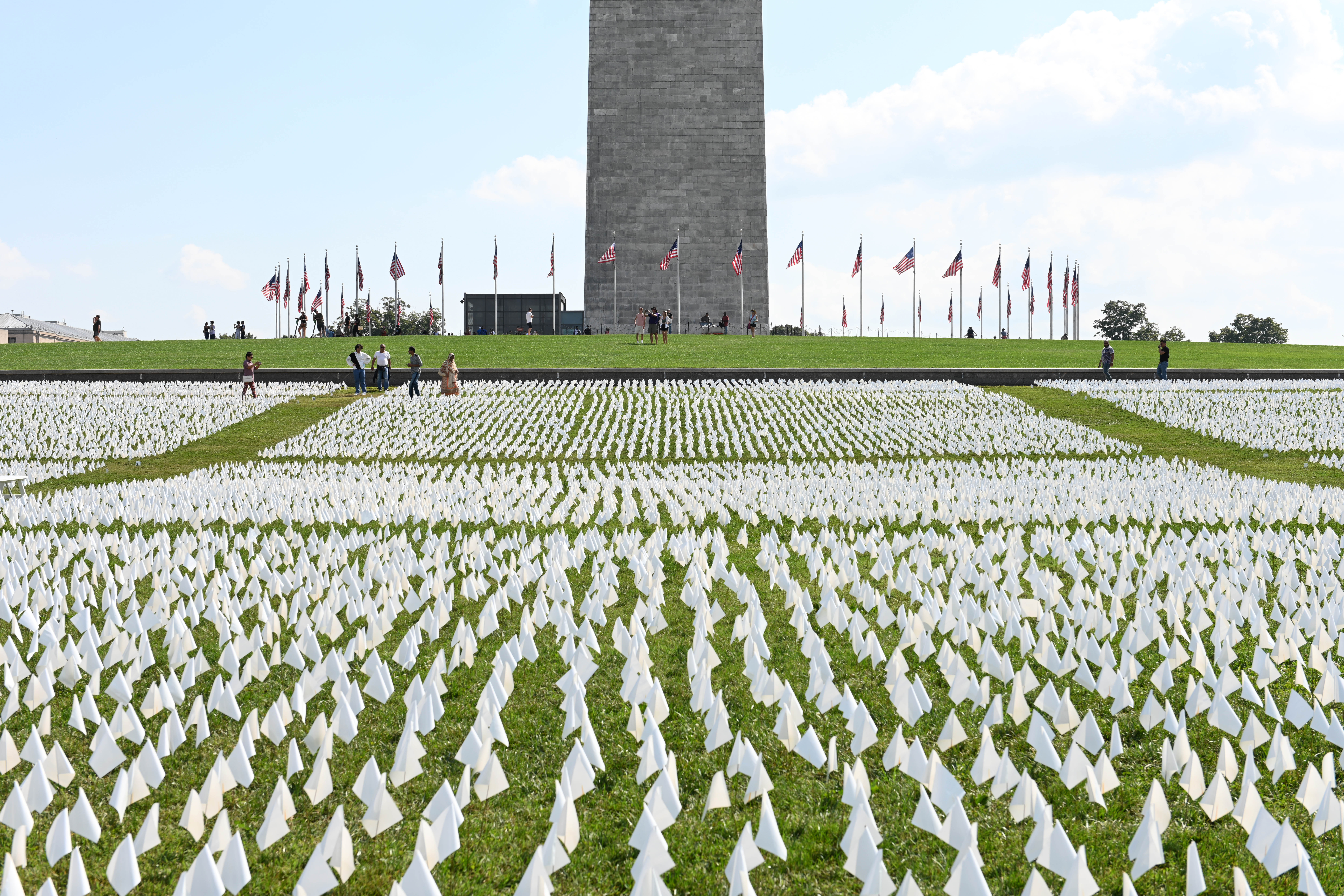 White flags are seen on the National Mall on September 18, 2021 in Washington, DC. Over 660,000 white flags were installed here to honor Americans who have lost their lives to COVID-19 epidemic. 