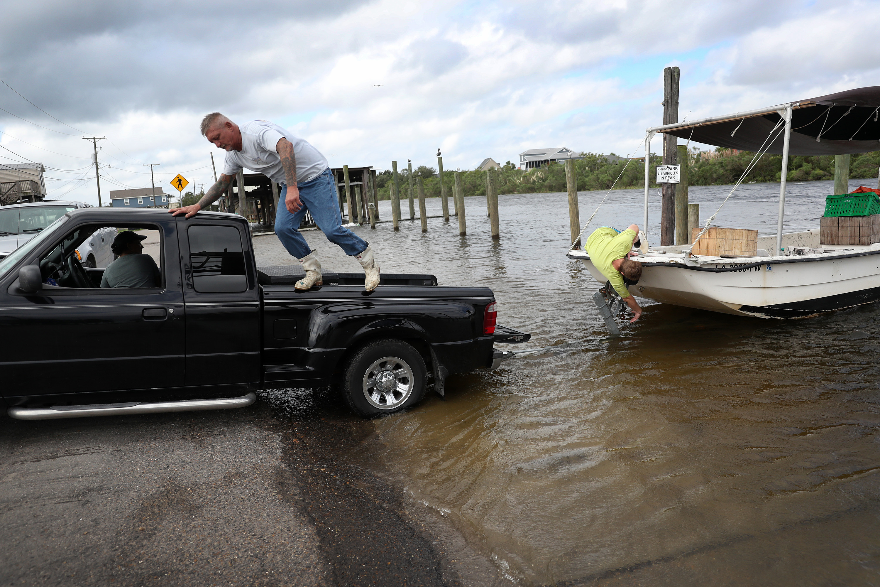 People take a boat out of the water on September 14 in Shell Beach, Louisiana, before the possible arrival of Hurricane Sally.