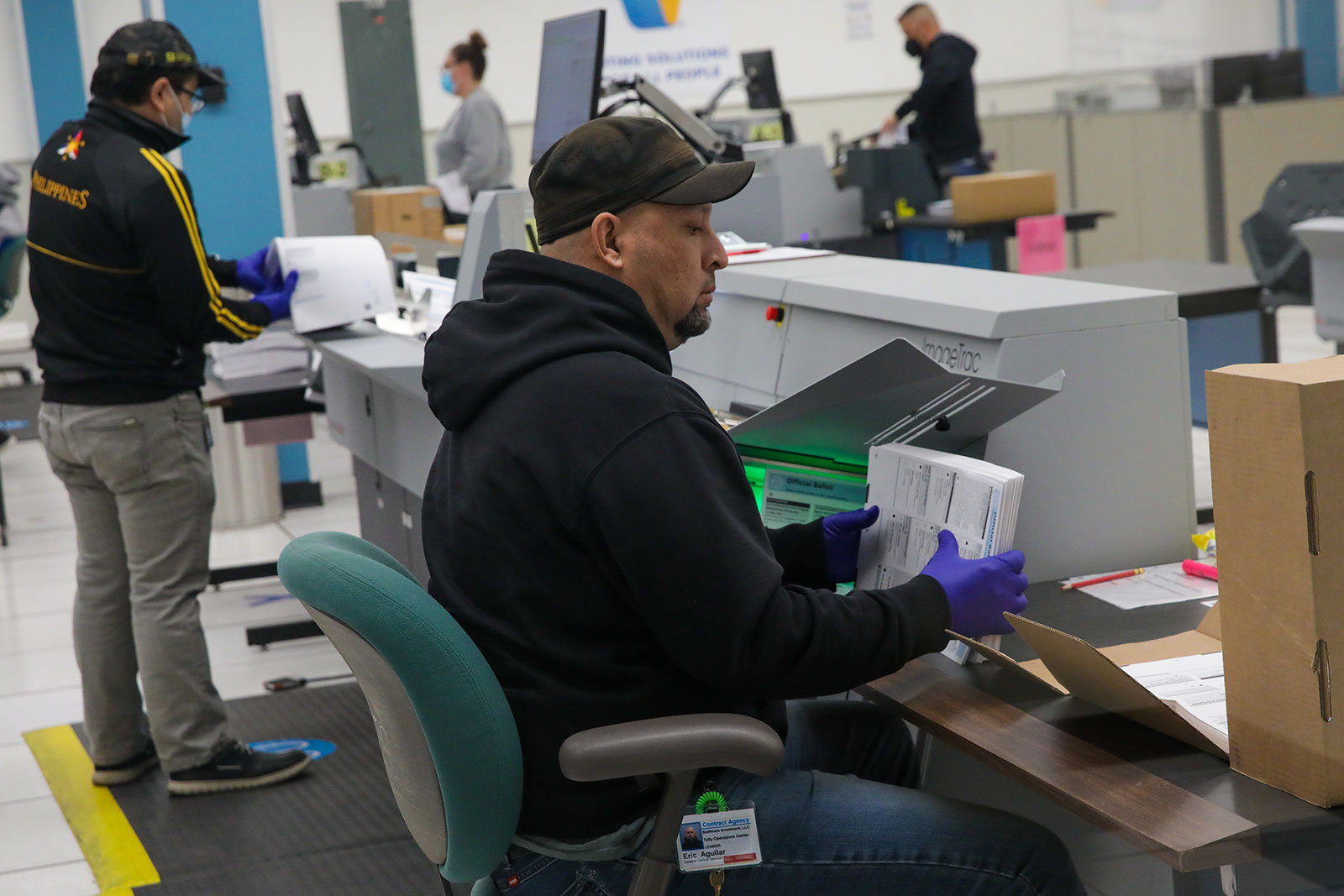 Eric Aguilar works on ballot scanning and tabulation of votes at the Voting Solutions for All People (VSAP) tally room on November 11 in Downey, California. 