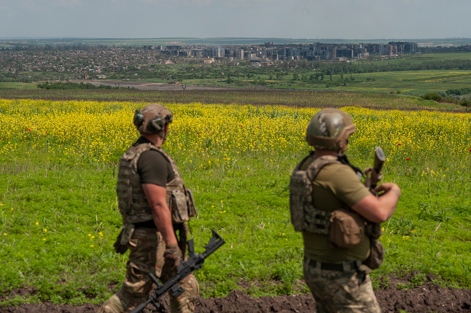 Ukrainian soldiers stand in position, with Bakhmut in the background, on June 5. 