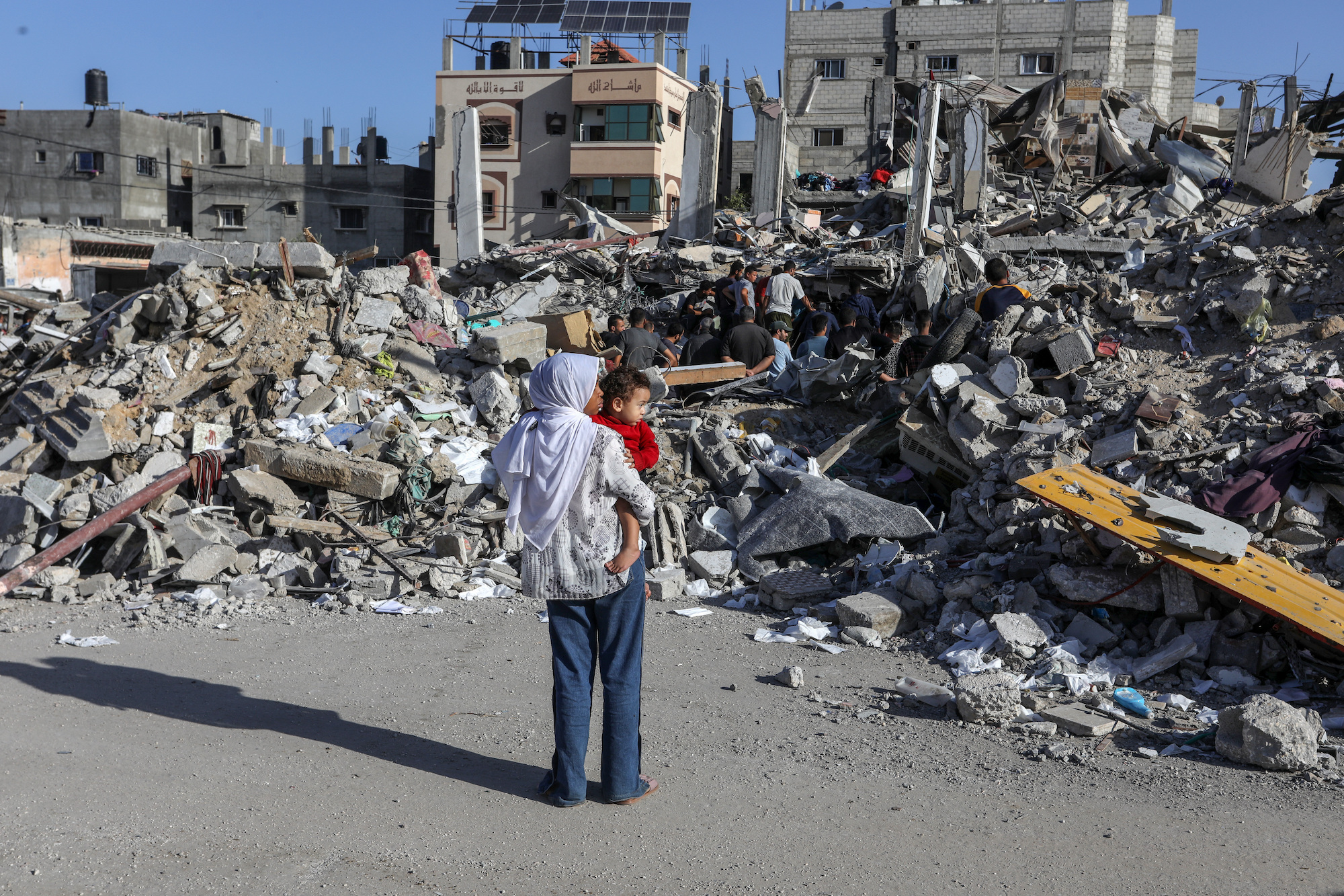 People search through rubble after Israeli airstrikes in Rafah, Gaza, on Friday.