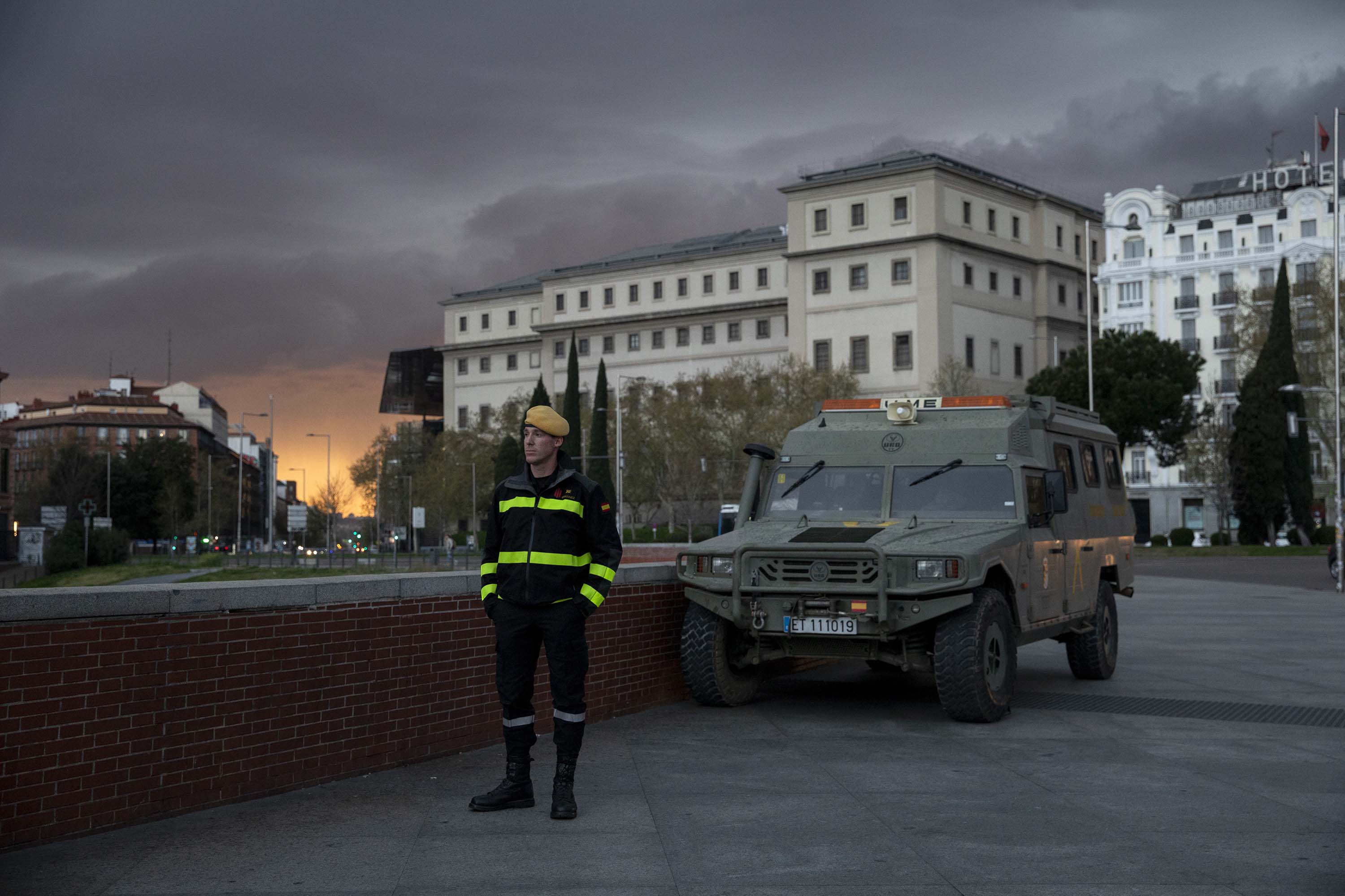 A member of Spanish Military Emergency Unit (UME) stands guard outside a train station in Madrid, Spain, on March 15.