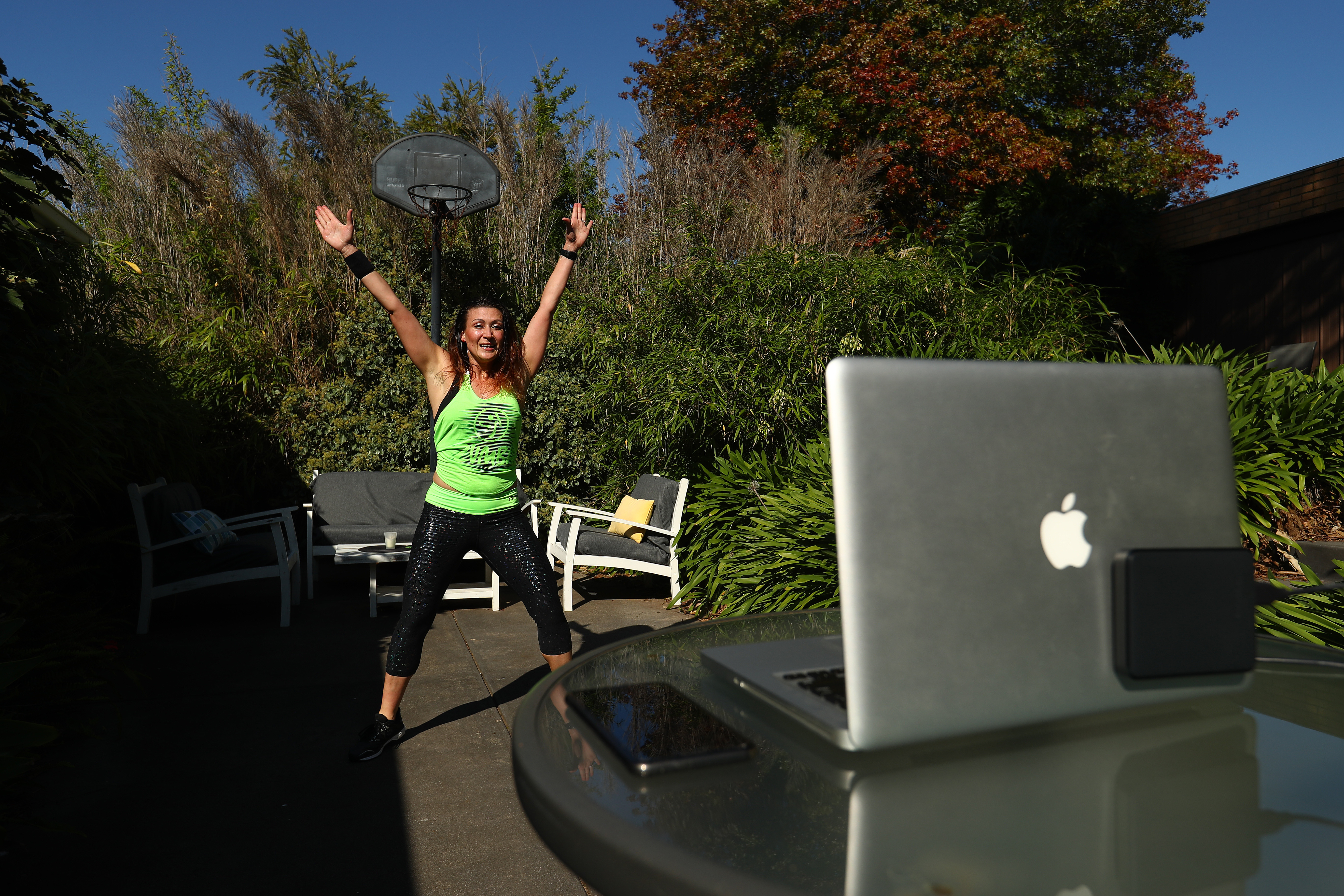 Zumba instructor Julia Basa leads an online session from her backyard in Melbourne, Australia, on April 9.