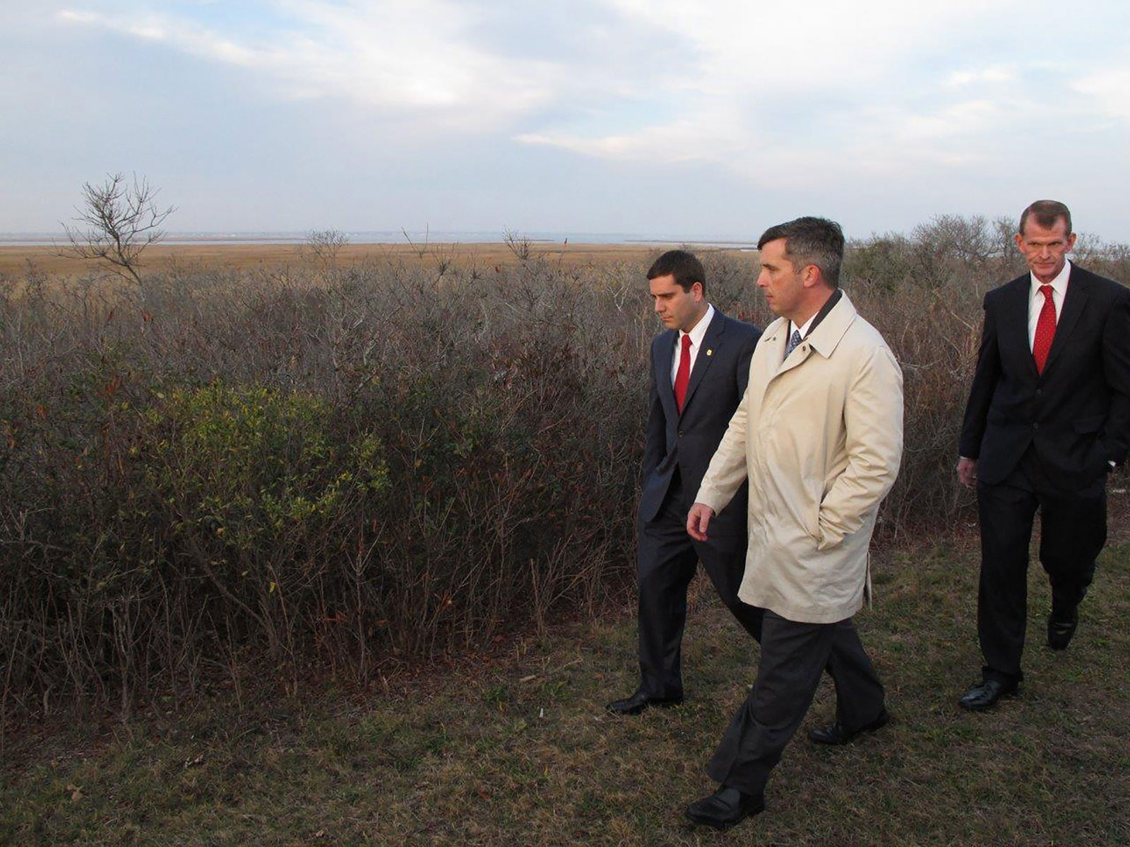Deputy Suffolk County Police Commissioner Tim Sini, left, homicide Detective Lt. Kevin Beyrer, center, and Chief of Department Stuart Cameron tour a remote area off a Long Island parkway in December 2015 where the bodies of 10 people were discovered in 2010 and 2011, in Babylon, New York. 