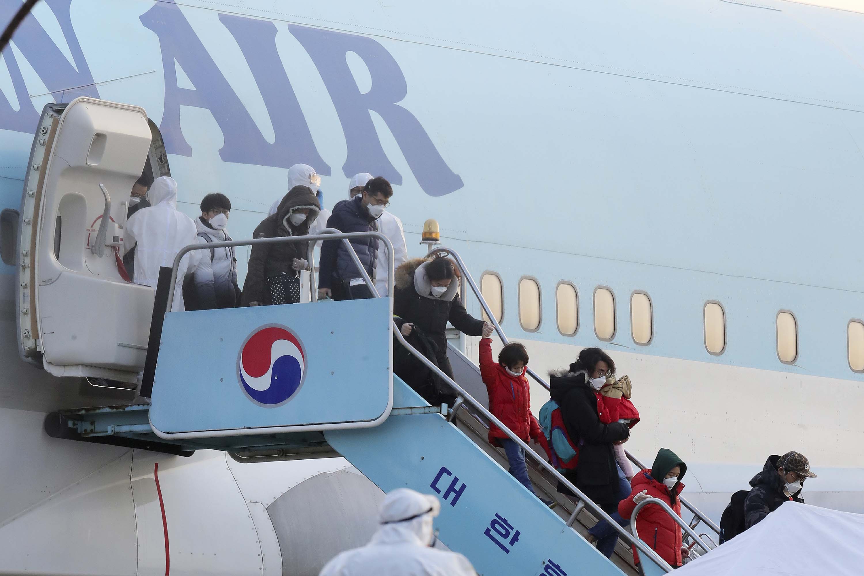 South Koreans evacuated from Wuhan disembark from a chartered flight in Seoul on Friday.