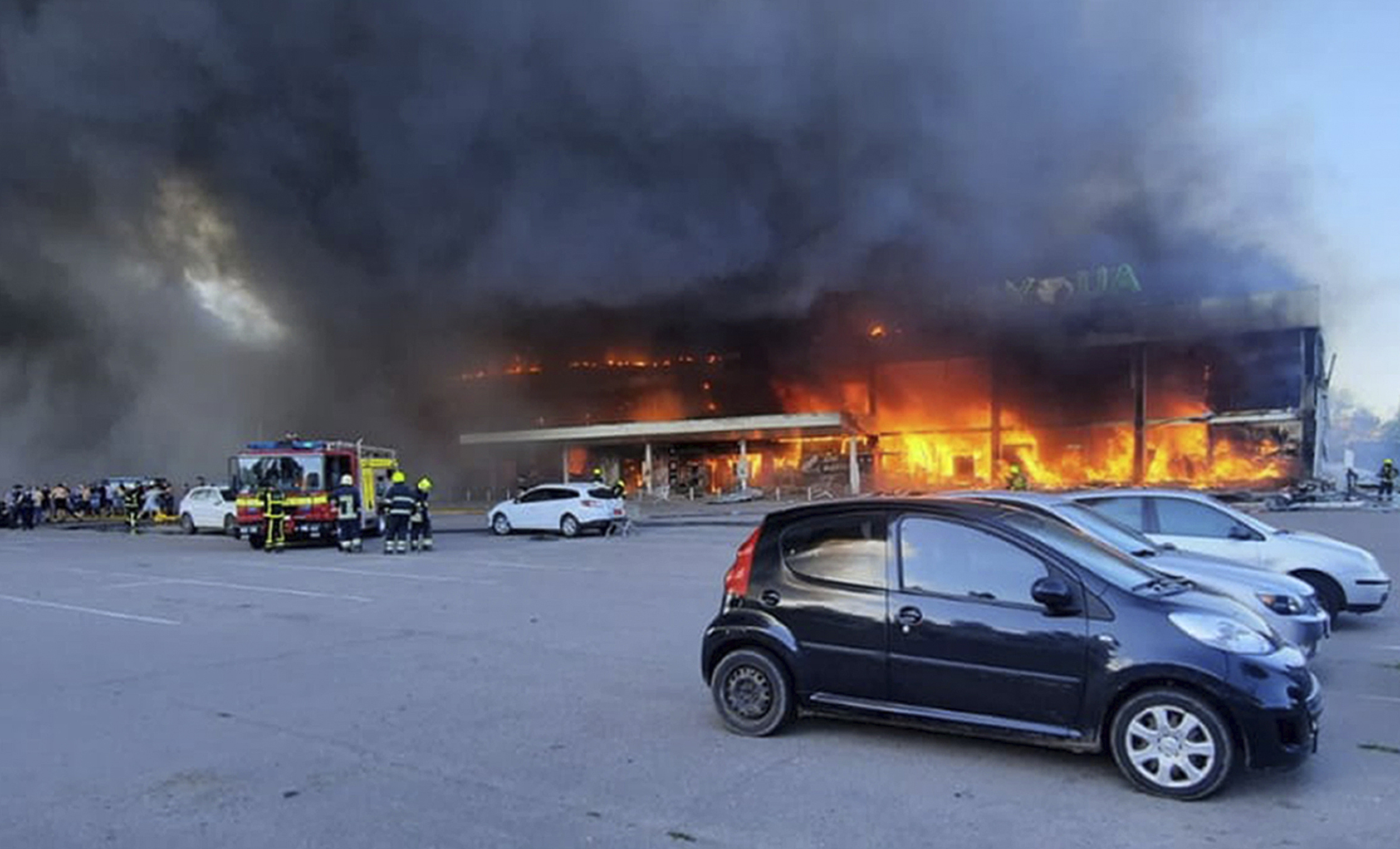 In this image made from video provided by Ukrainian State Emergency Service, firefighters work to extinguish a fire at a shopping center after a rocket attack in Kremenchuk, Ukraine, on June 27.