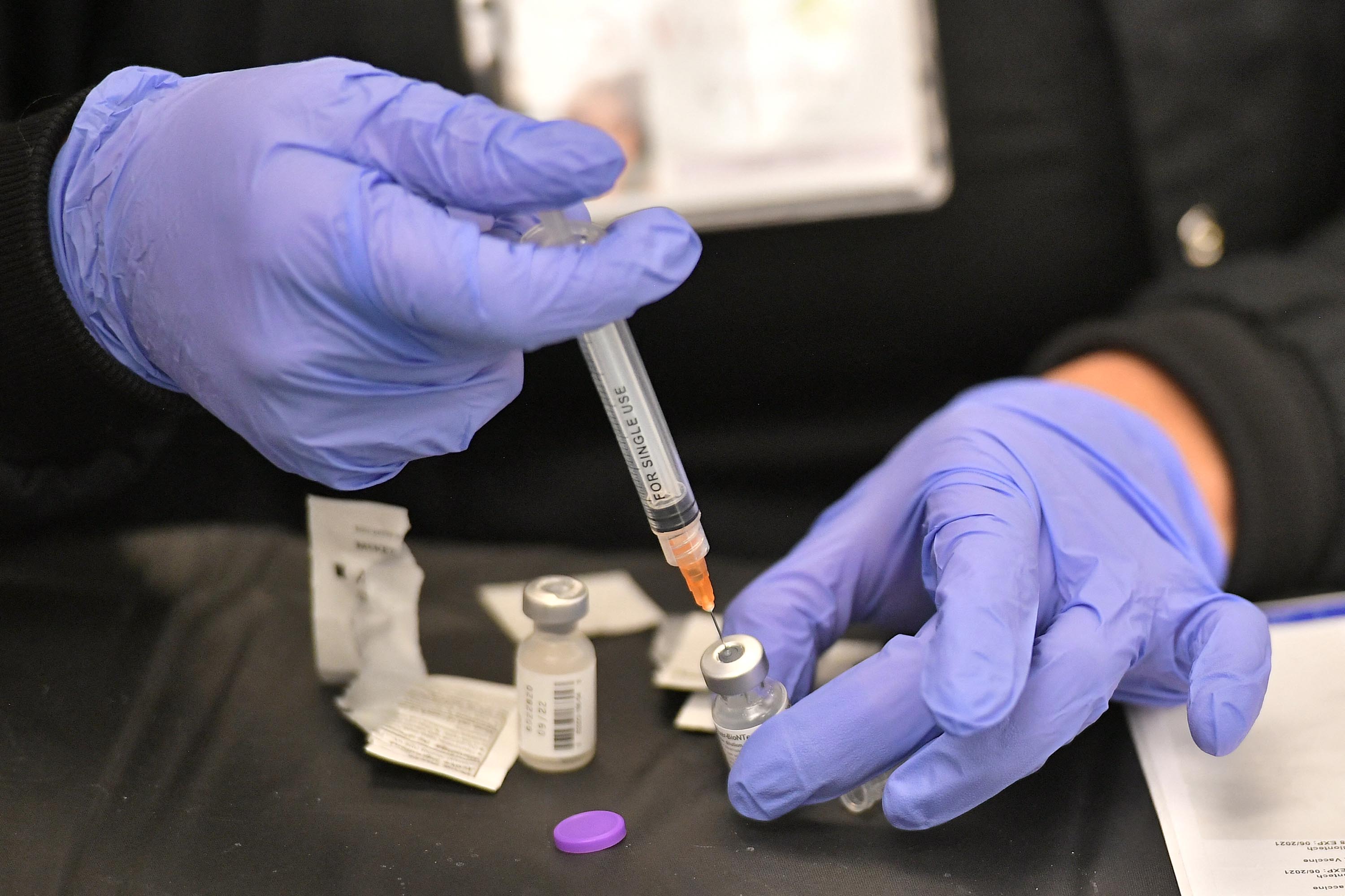A health worker prepares a dose of the Pfizer/BioNTech vaccine at a Covid-19 vaccination site in Las Vegas on March 15. 