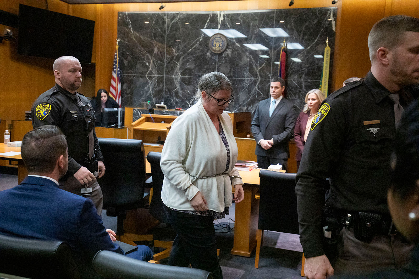 Jennifer Crumbley exits from the courtroom in Oakland County Circuit Court after the jury found her guilty on four counts of involuntary manslaughter on Tuesday in Pontiac, Michigan. 