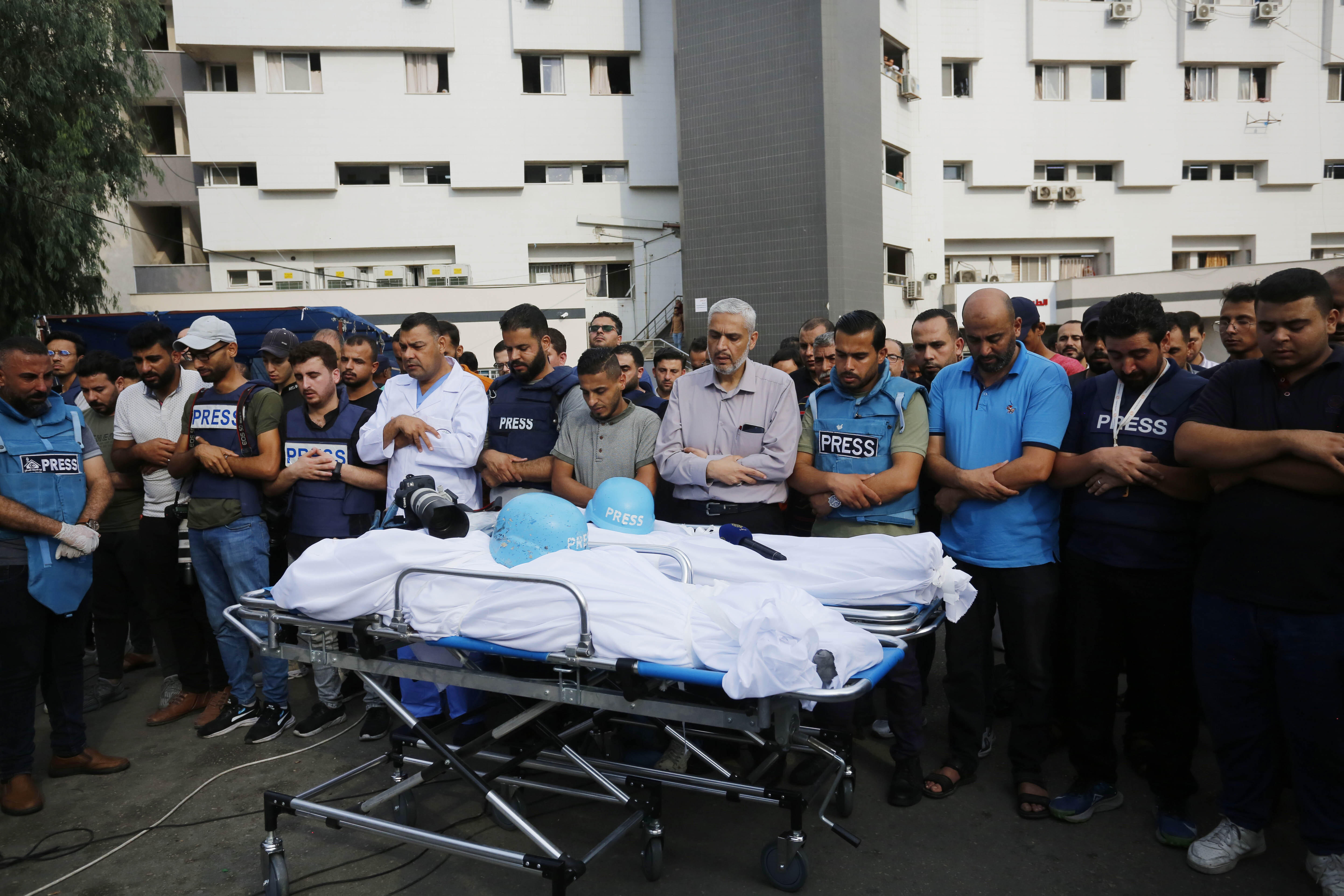 Relatives and colleagues of Palestinian journalists Saeed Al-Taweel and Mohammad Sobh, who were killed in Israeli airstrikes, perform a funeral prayer in Gaza on October 10.