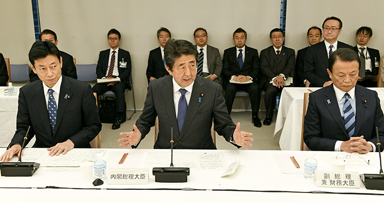 Japanese Prime Minister Shinzo Abe, center, speaks during a meeting on the coronavirus crisis on March 20, in Tokyo.