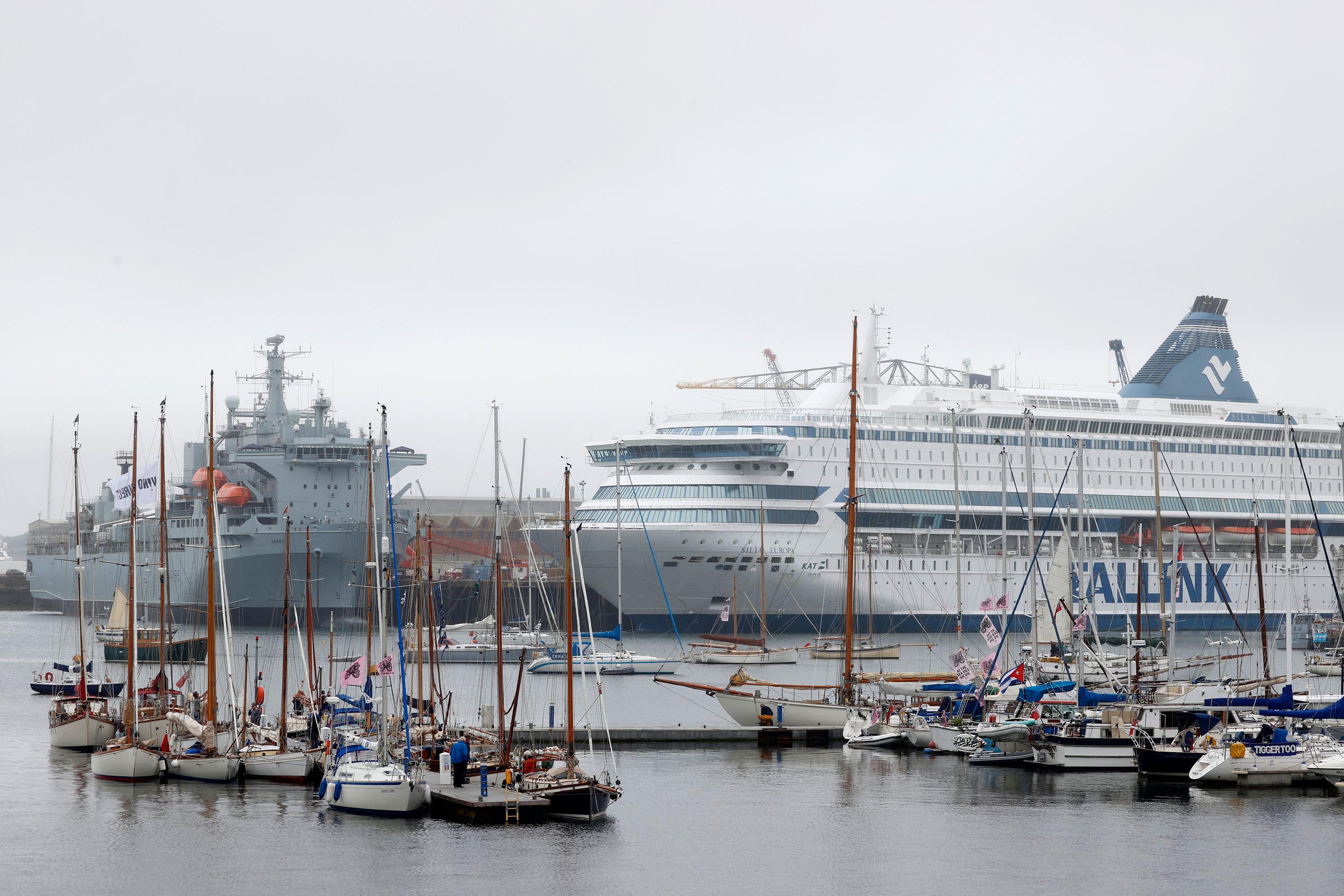 The MS Silja Europa, (R), which is housing police officers, is berthed in the harbor at Falmouth, Cornwall on June 10.