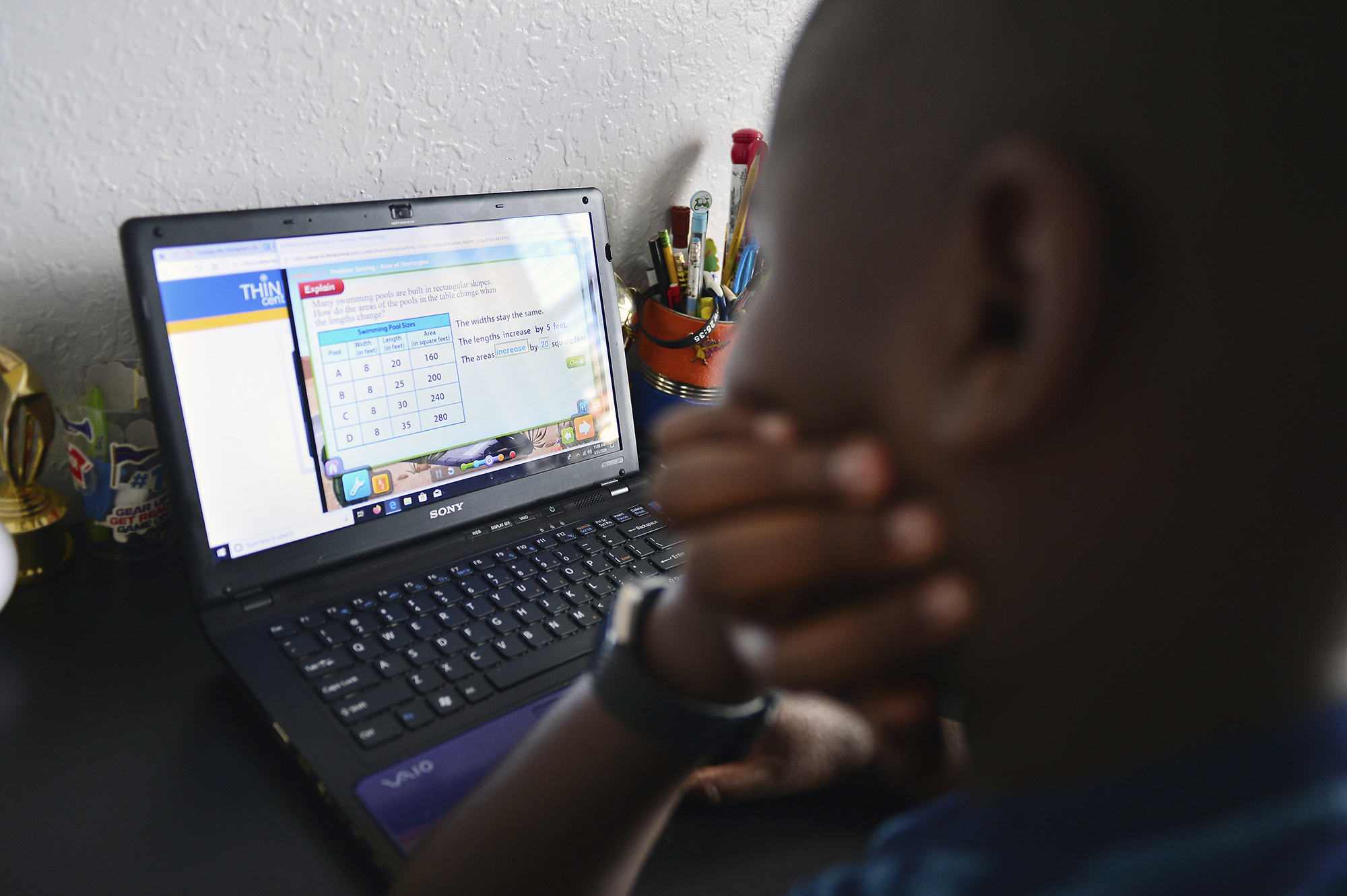 In this March 31 file photo, 9-year-old Jordan works on an online assignment after his school in Miramar, Florida, went virtual following the coronavirus outbreak in the United States.