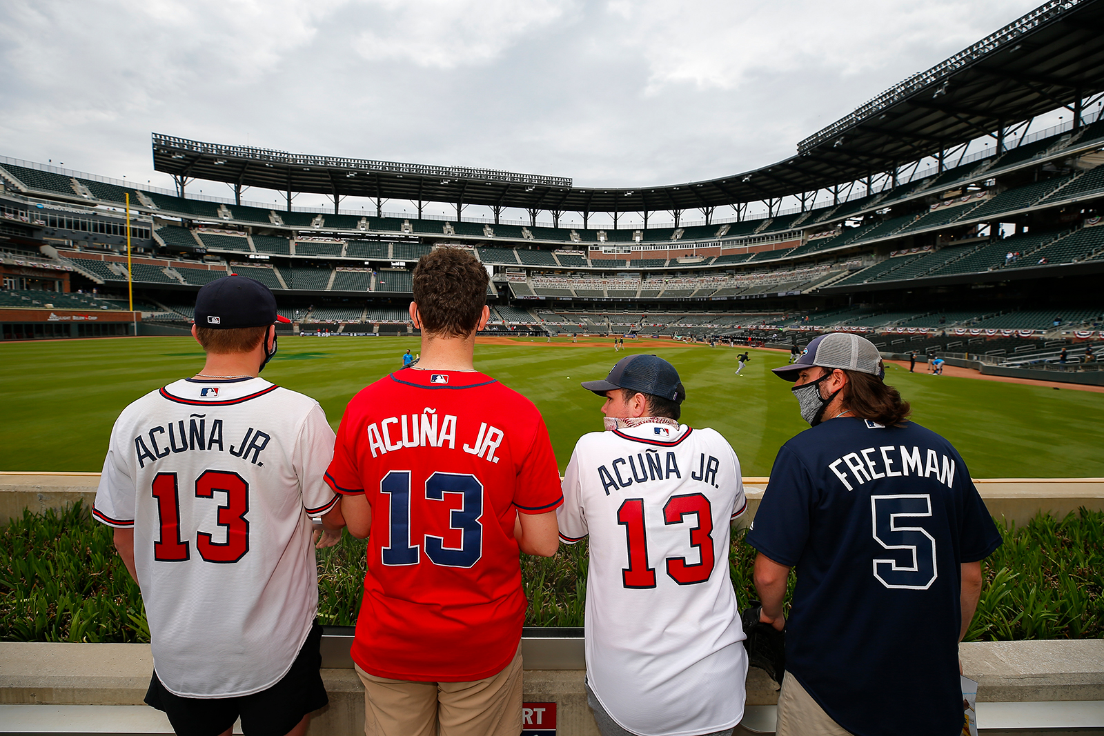 Atlanta Braves fans look on while players warm up prior to an MLB game between the Miami Marlins and Atlanta Braves at Truist Park on April 15, in Atlanta. 