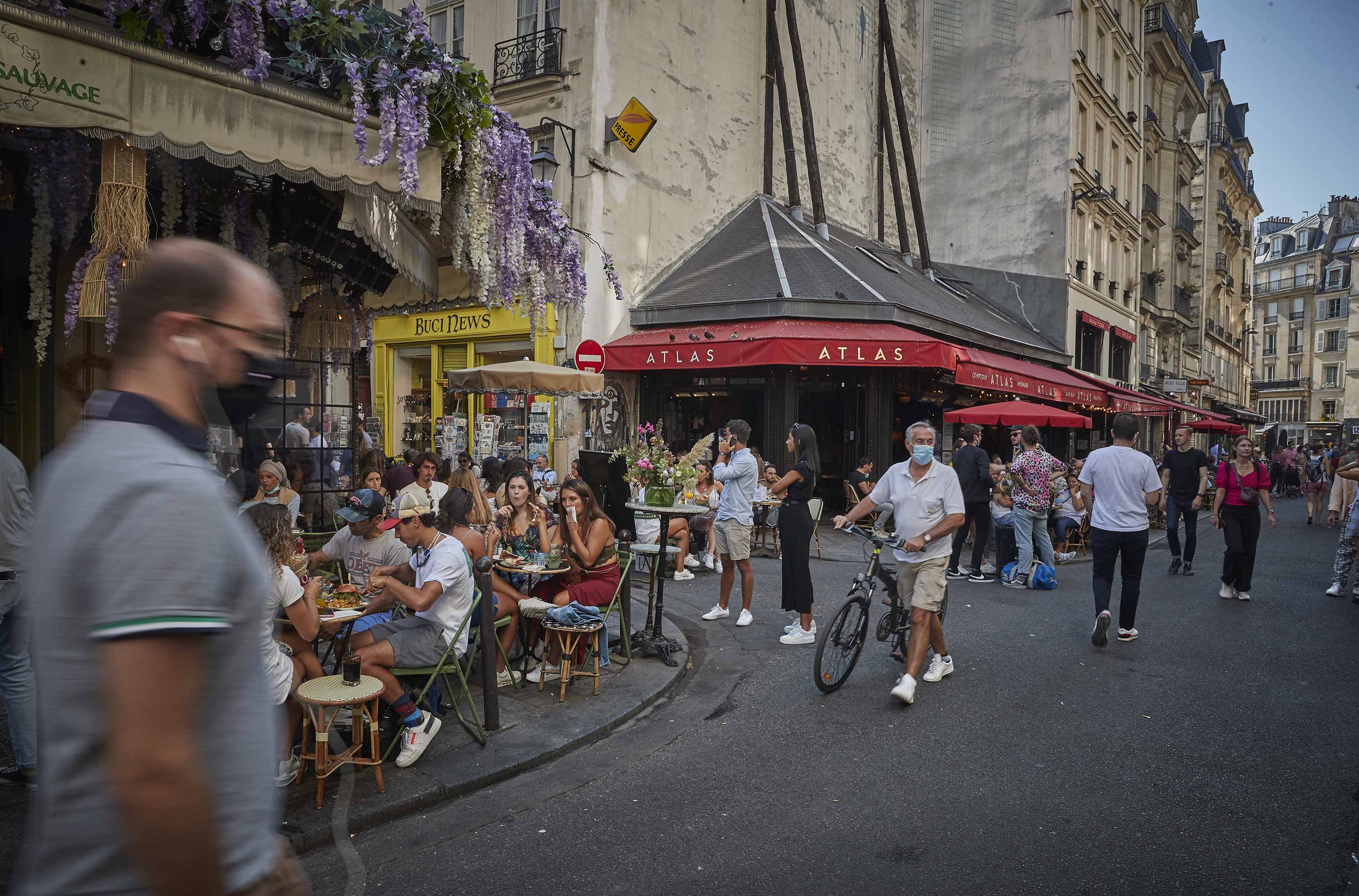 Parisians enjoy warm weather and outdoor seating at busy cafes and restaurants in Paris, on September 13.