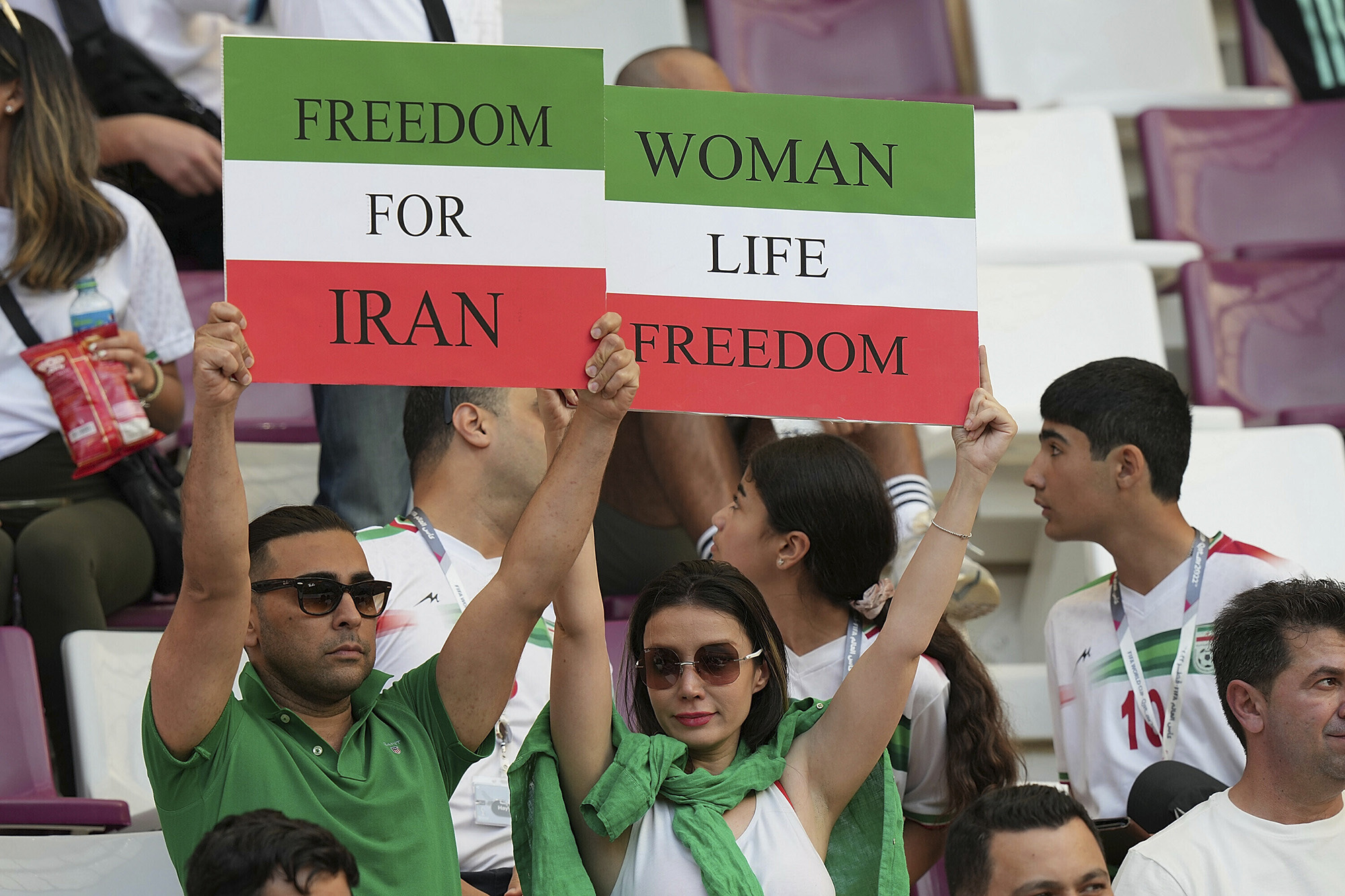Iranian fans hold up banners in the stadium.
