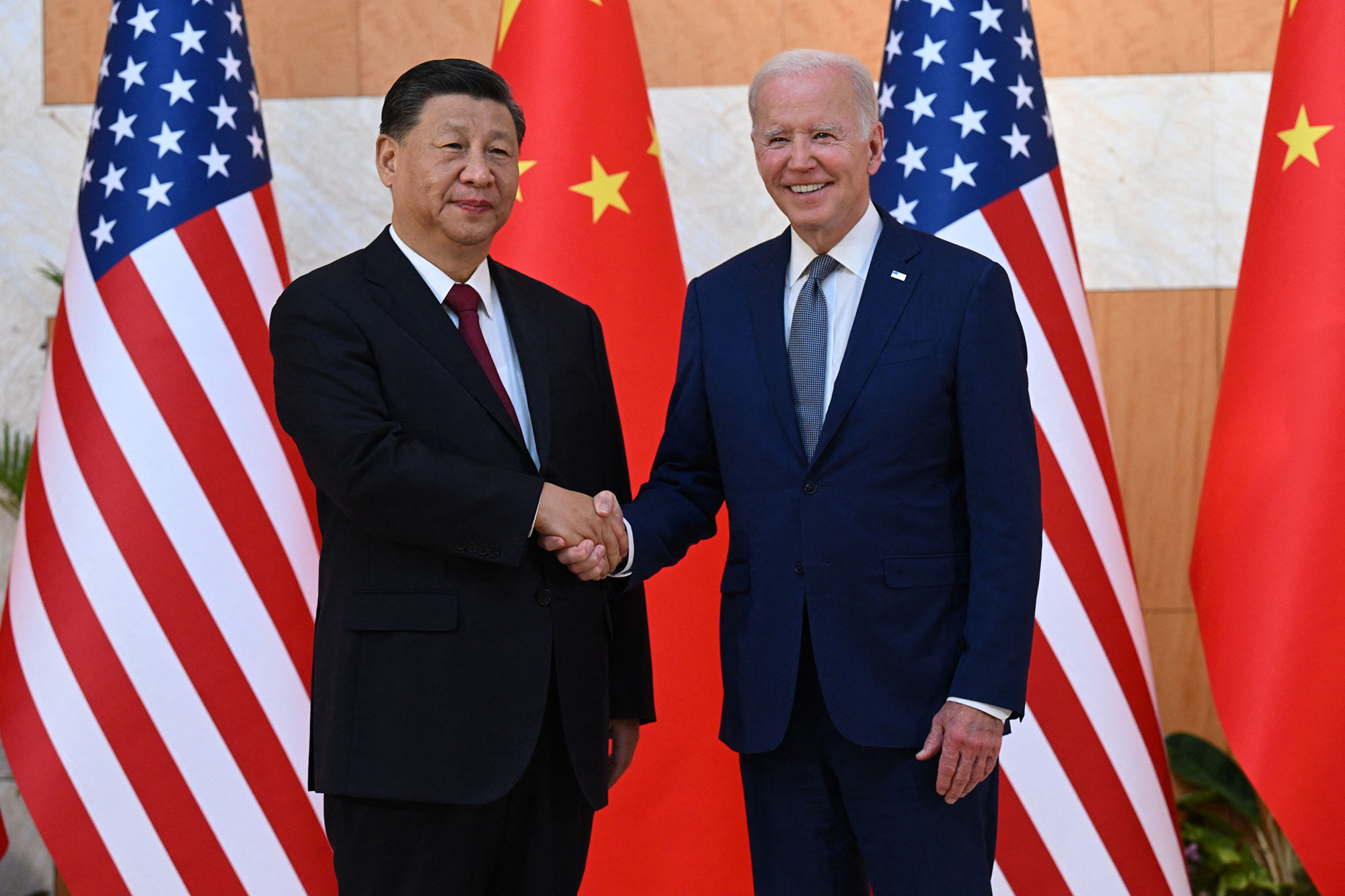 US President Joe Biden, right, and China's President Xi Jinping shake hands as they meet on the sidelines of the G20 Summit in Nusa Dua on the Indonesian resort island of Bali on November 14.