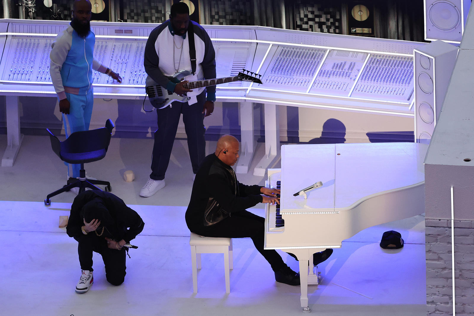 Eminem kneels next to Dr. Dre during the Pepsi Super Bowl LVI Halftime Show.