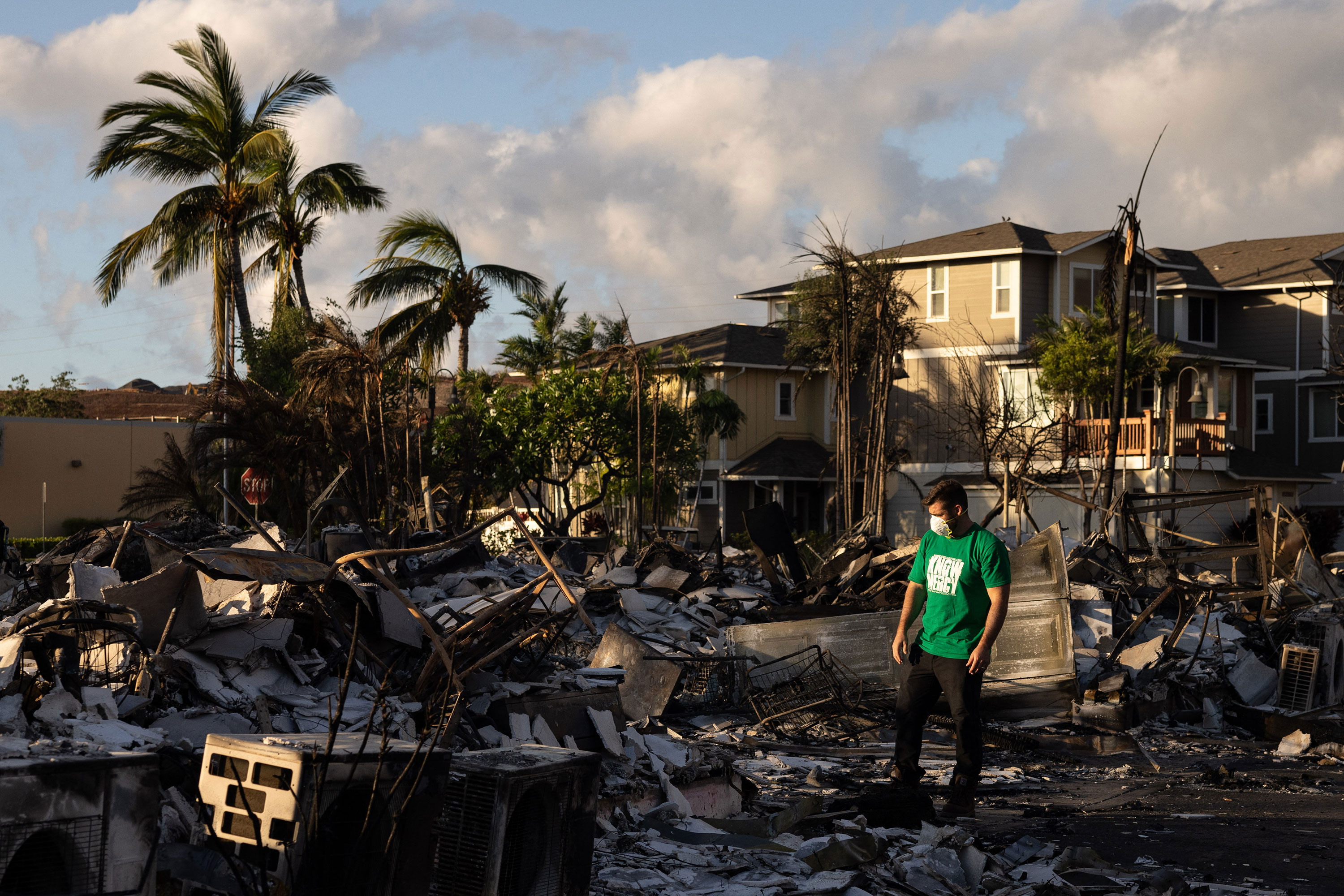  A Mercy Worldwide volunteer assesses the damage to an apartment complex in Lahaina, Hawaii, on Saturday. 