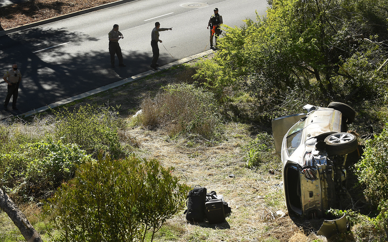 L.A. County Sheriff's officers investigate an accident involving famous golfer Tiger Woods along Hawthorne Blvd. in Ranch Palos Verdes on Tuesday.