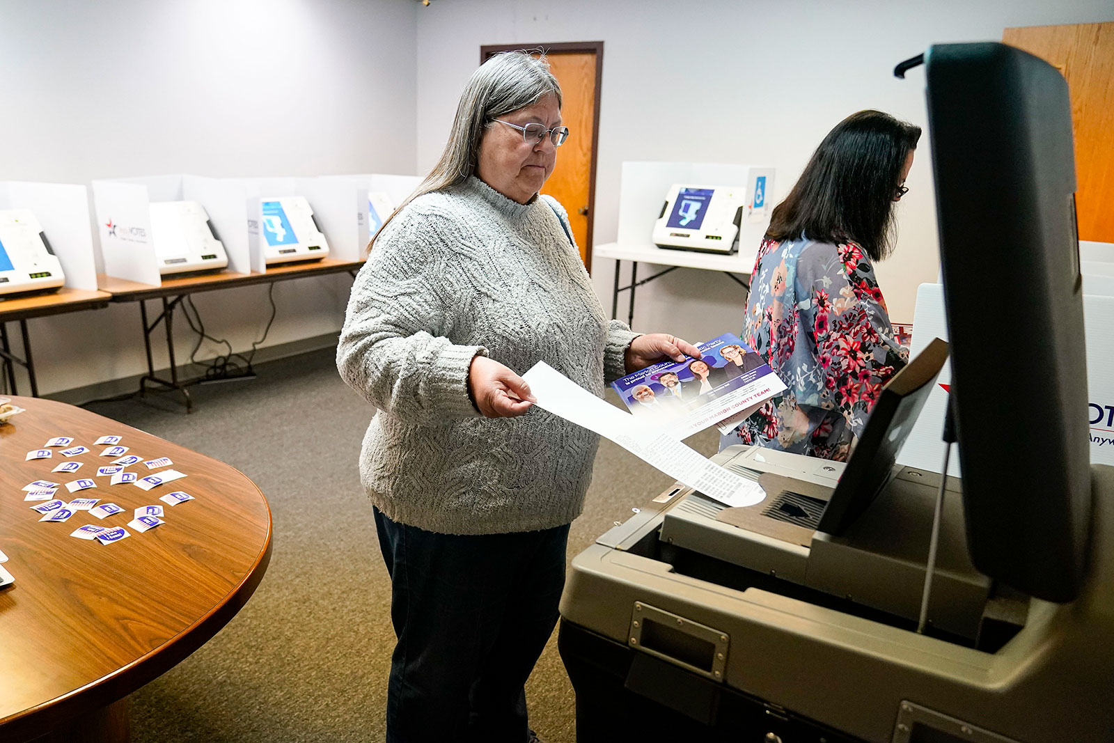 A voter inserts her ballot into a scanner as she votes in the primary election in Indianapolis, Indiana, on Tuesday, May 3.
