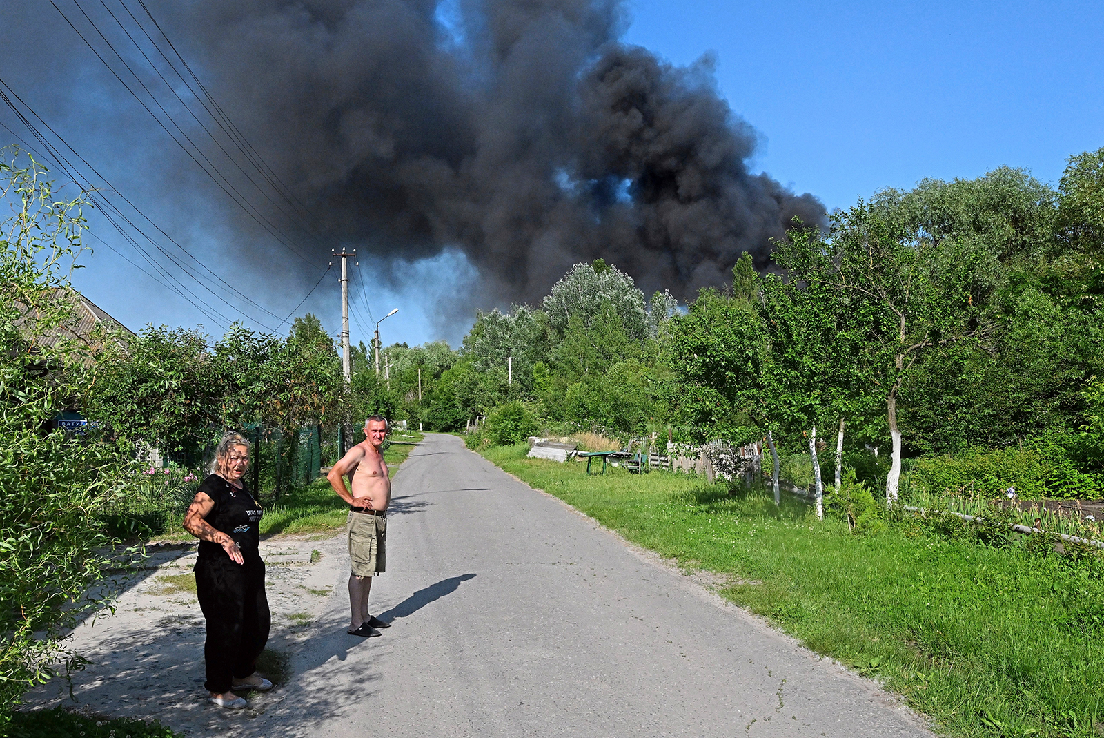 Residents stand in the street as smoke rises, following shelling in Belgorod, Russia, on June 2. 