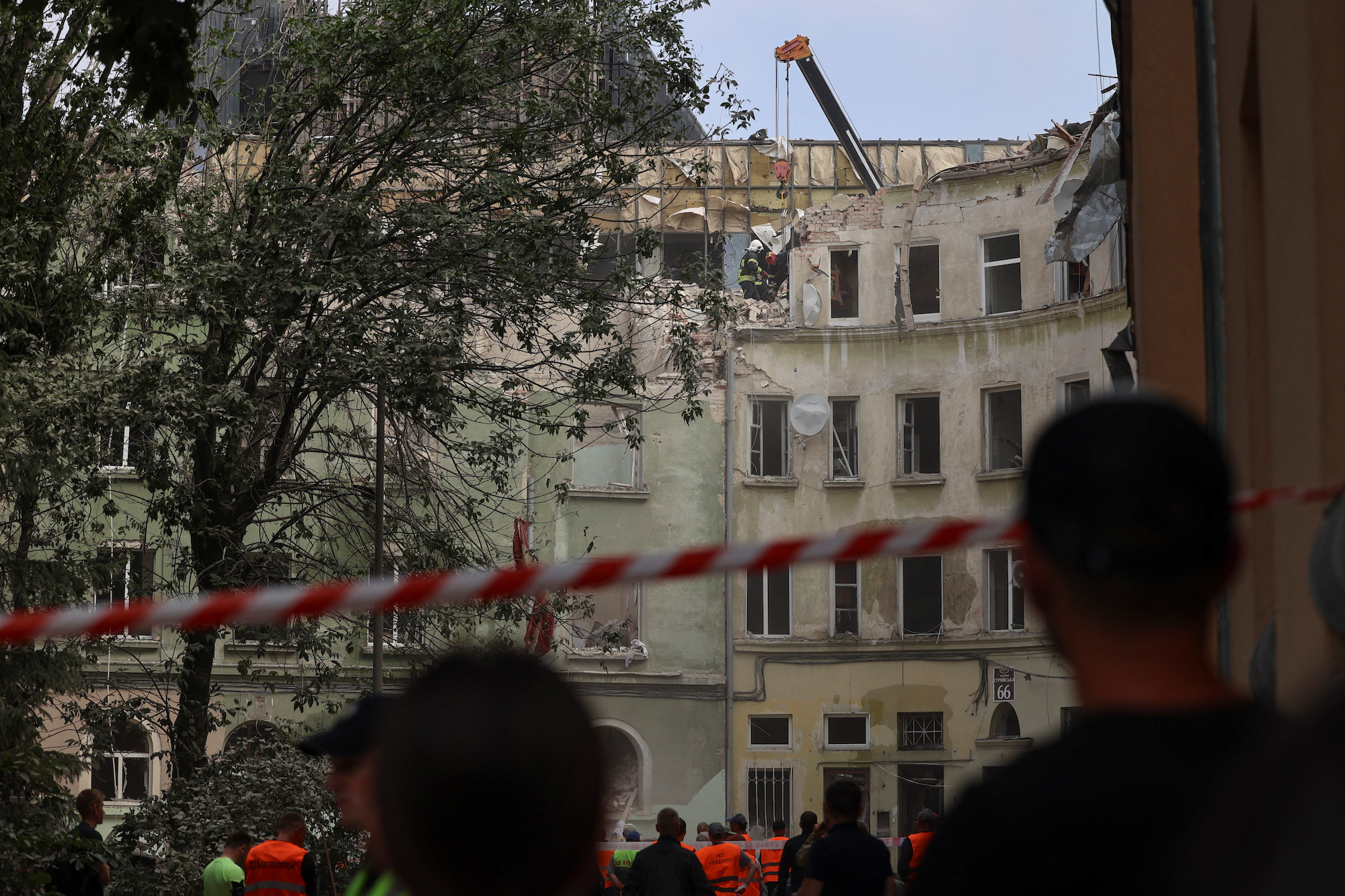 Rescuers work at the site of a Russian missile strike in Lviv on Thursday. 