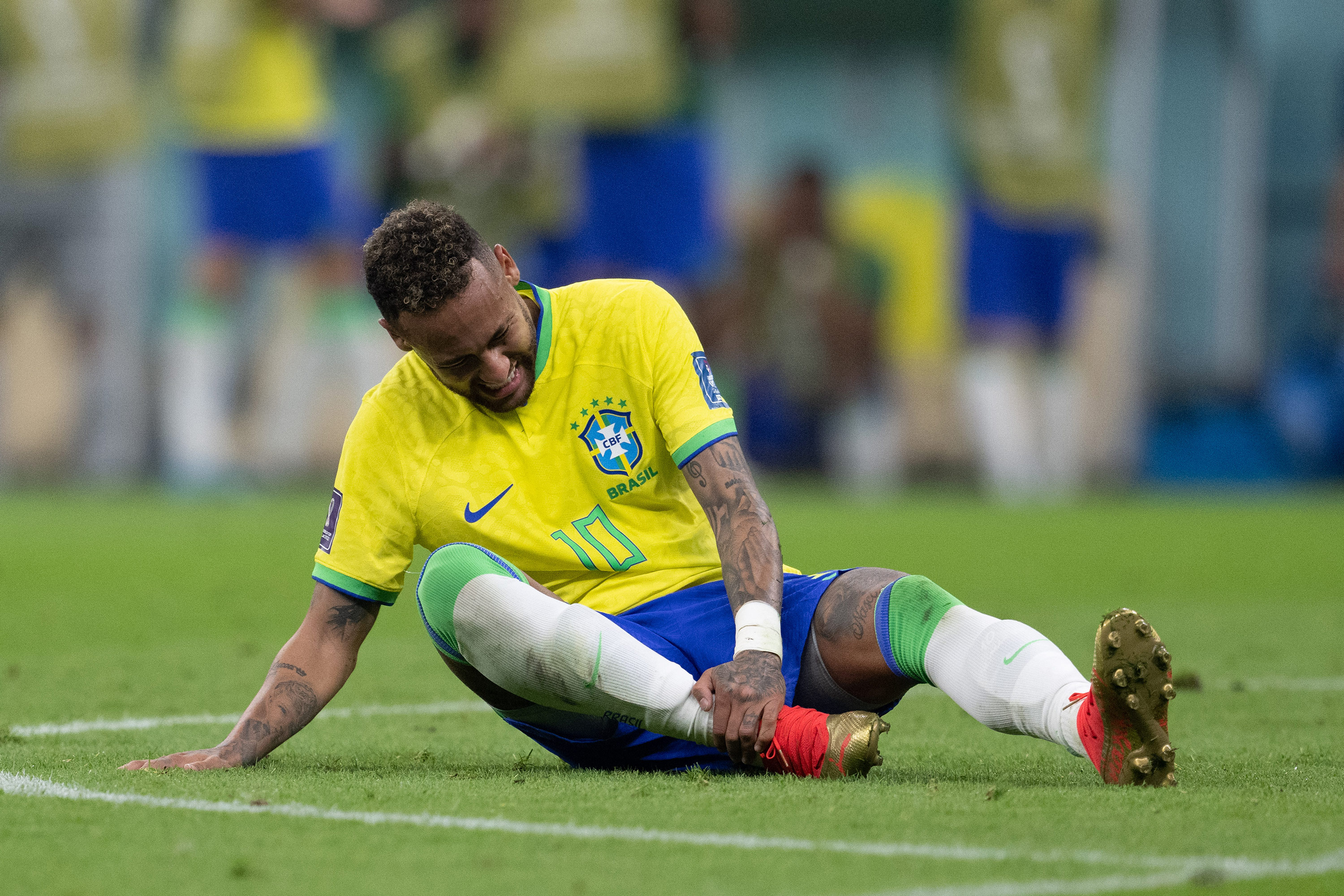 Brazil’s Neymar holds his ankle during the match against Serbia on November 24. 