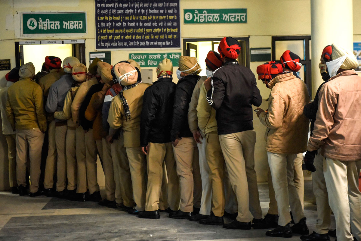 Punjab Police personnel stand in a queue as they wait register for Covid-19 tests at the Community Health Centre on the outskirts of Amritsar, India on January 25.
