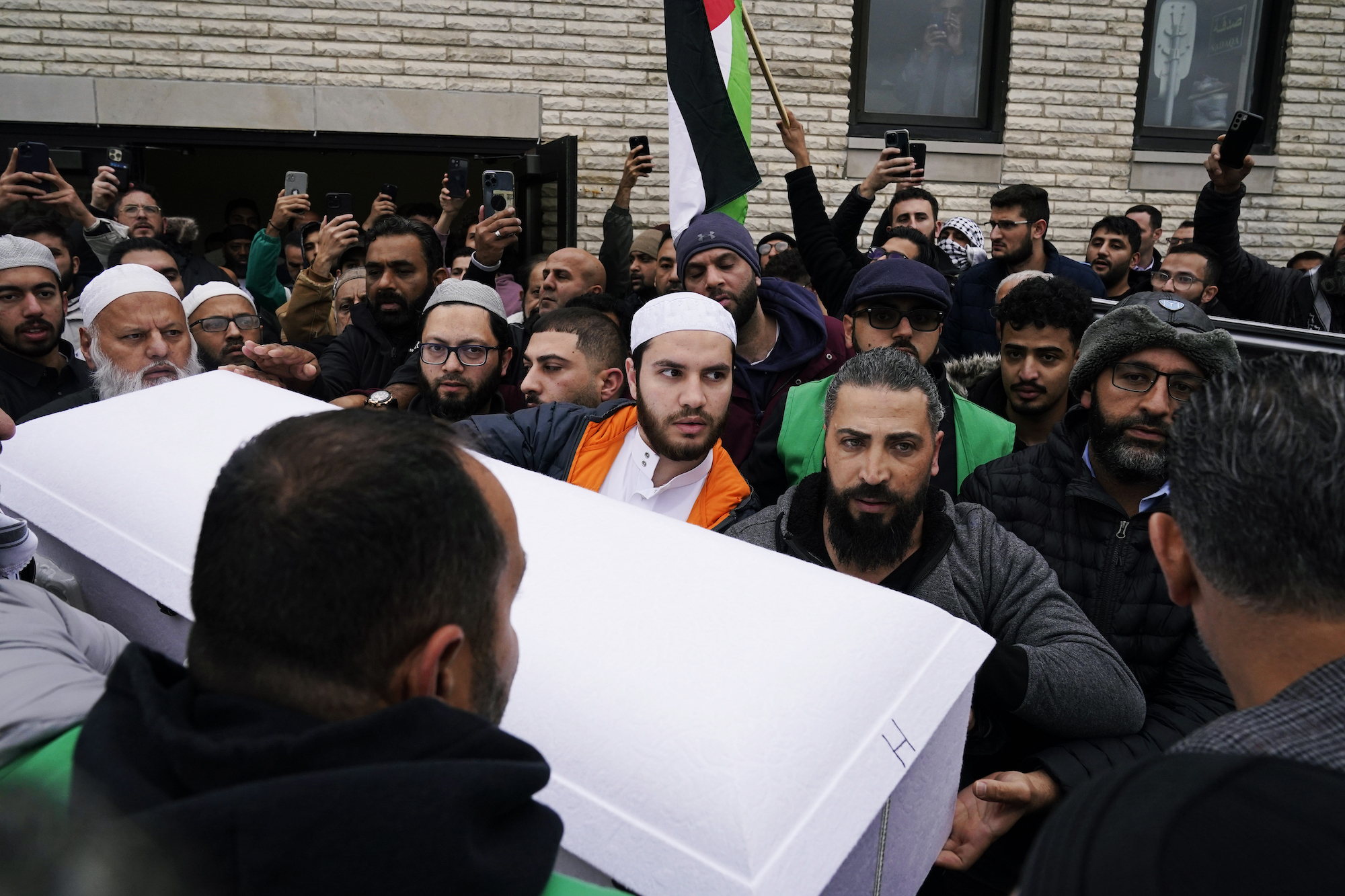 Family members of Wadea Al Fayoume, a six year-old who was stabbed to death, bring out his casket from Mosque Foundation to the hearse in Bridgeview, Illinois, on October 16.