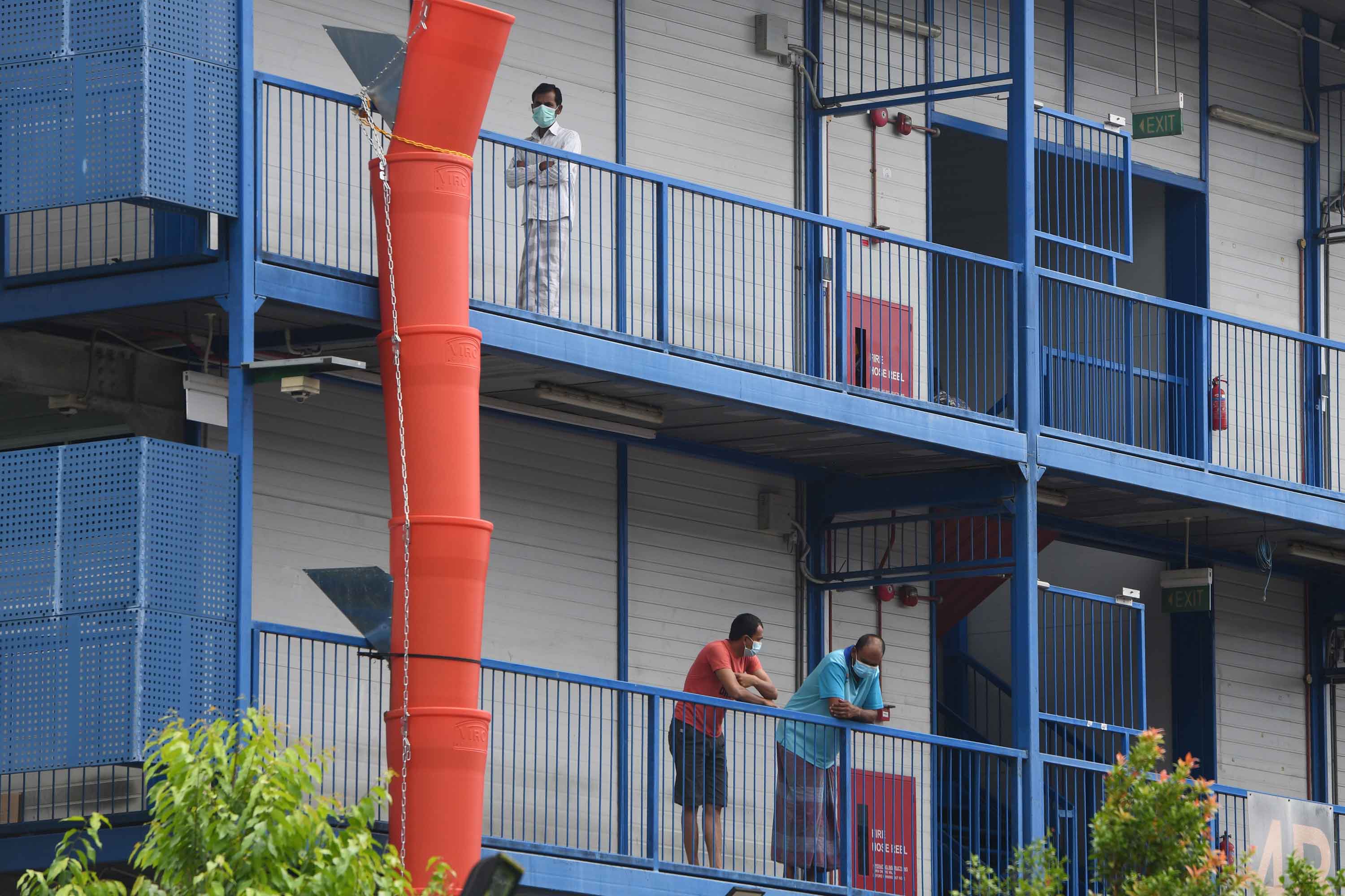 Migrant workers are seen at a quarantined dormitory building in Singapore on May 20.