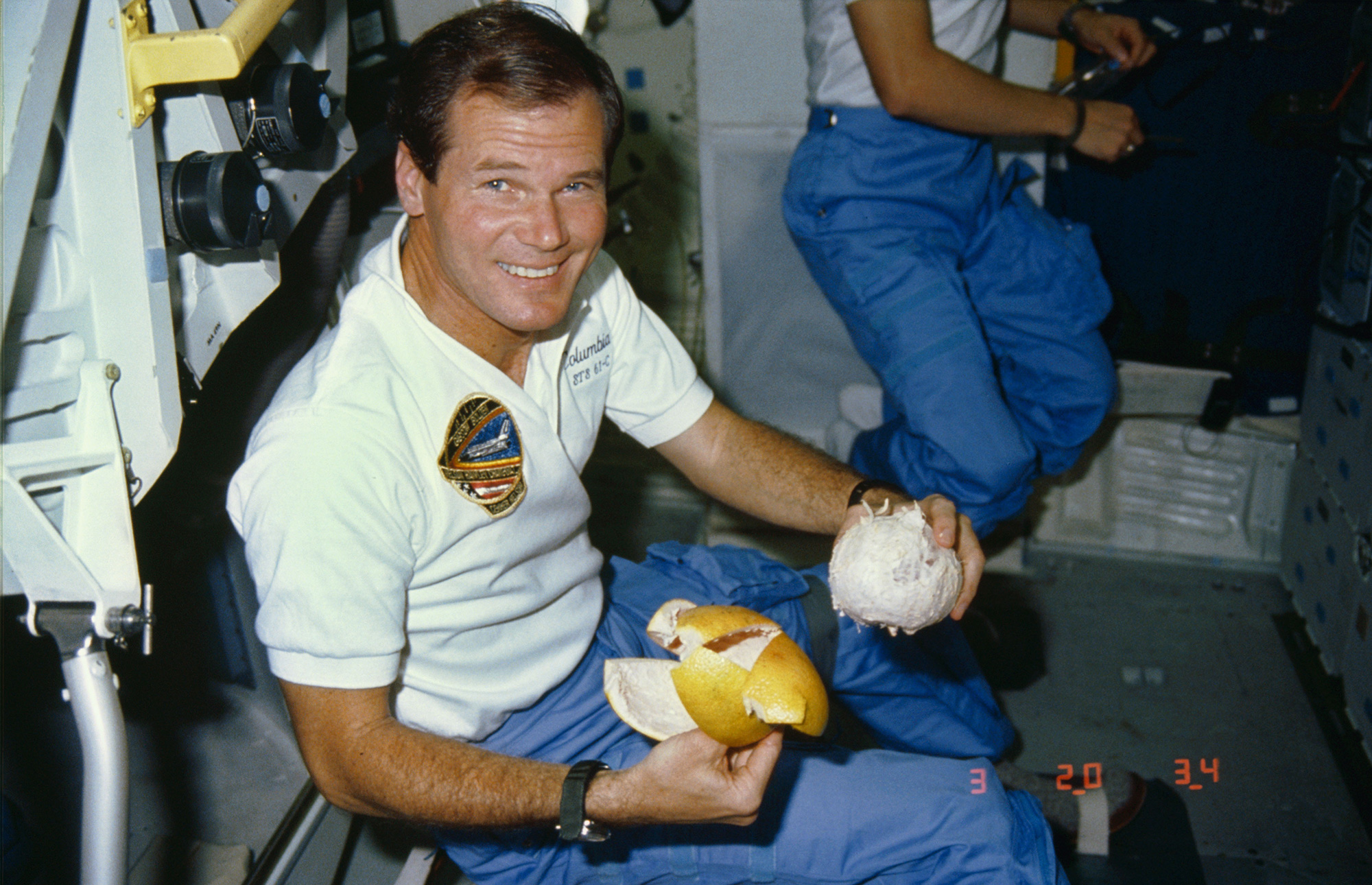 Bill Nelson peels a grapefruit on NASA's Columbia space shuttle during an Earth orbit between January 12 and 19, 1986. 