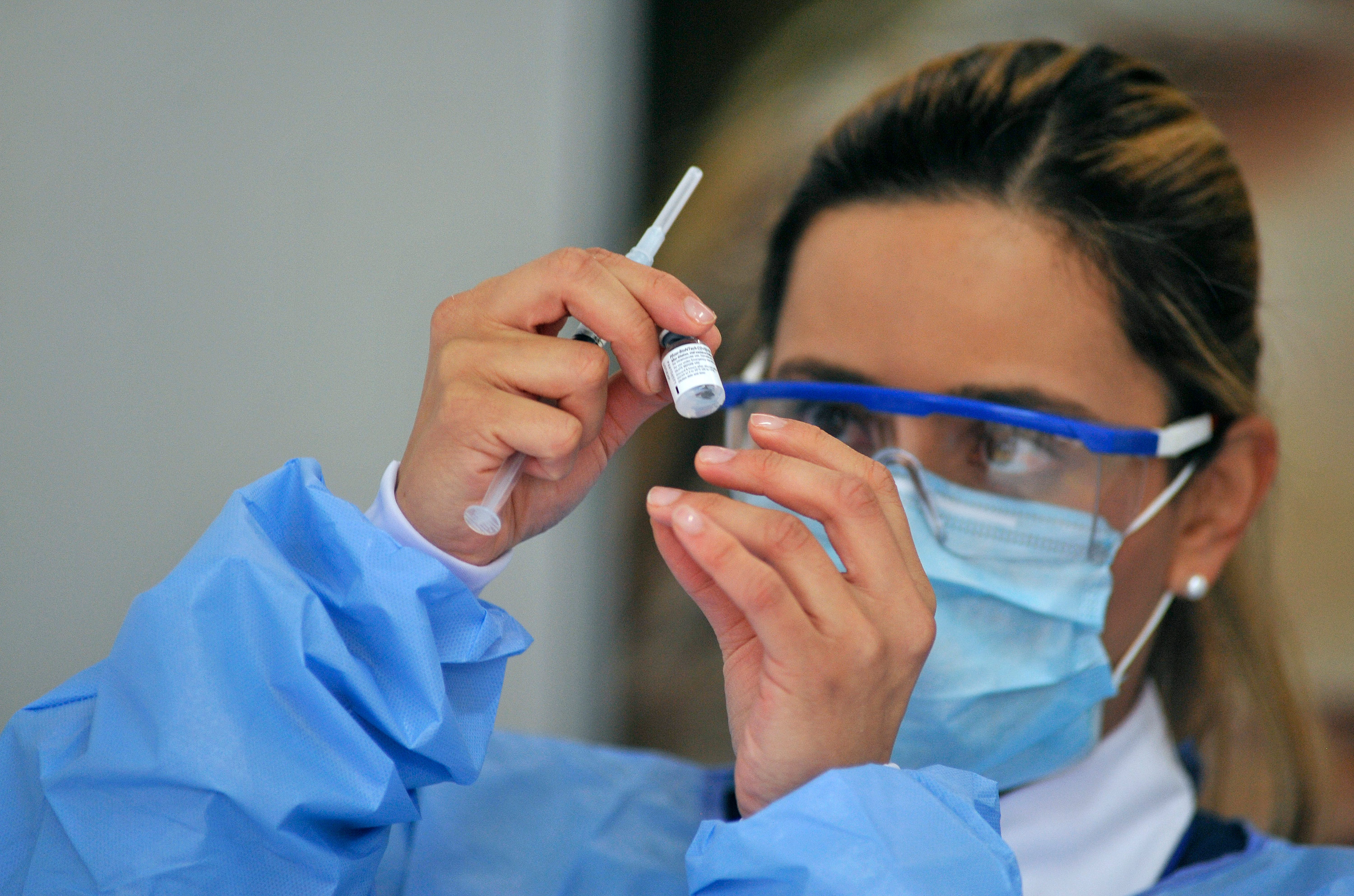 A healthcare worker prepares a dose of the Pfizer-BioNTech Covid-19 vaccine on February 18, in Bogota, Colombia. 